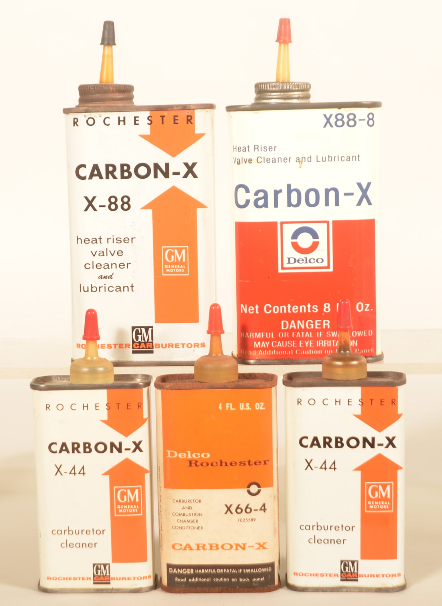 Delco & GM Vintage Handy Oilers: Five different oil cans including a paper label over litho Delco Rochester Carbon-X 4 oz. can, Delco Carbon-X 8 oz. can, two slightly different 4 oz. GM Carbon-X cans, and an 8 oz. GM Rochester Carbon