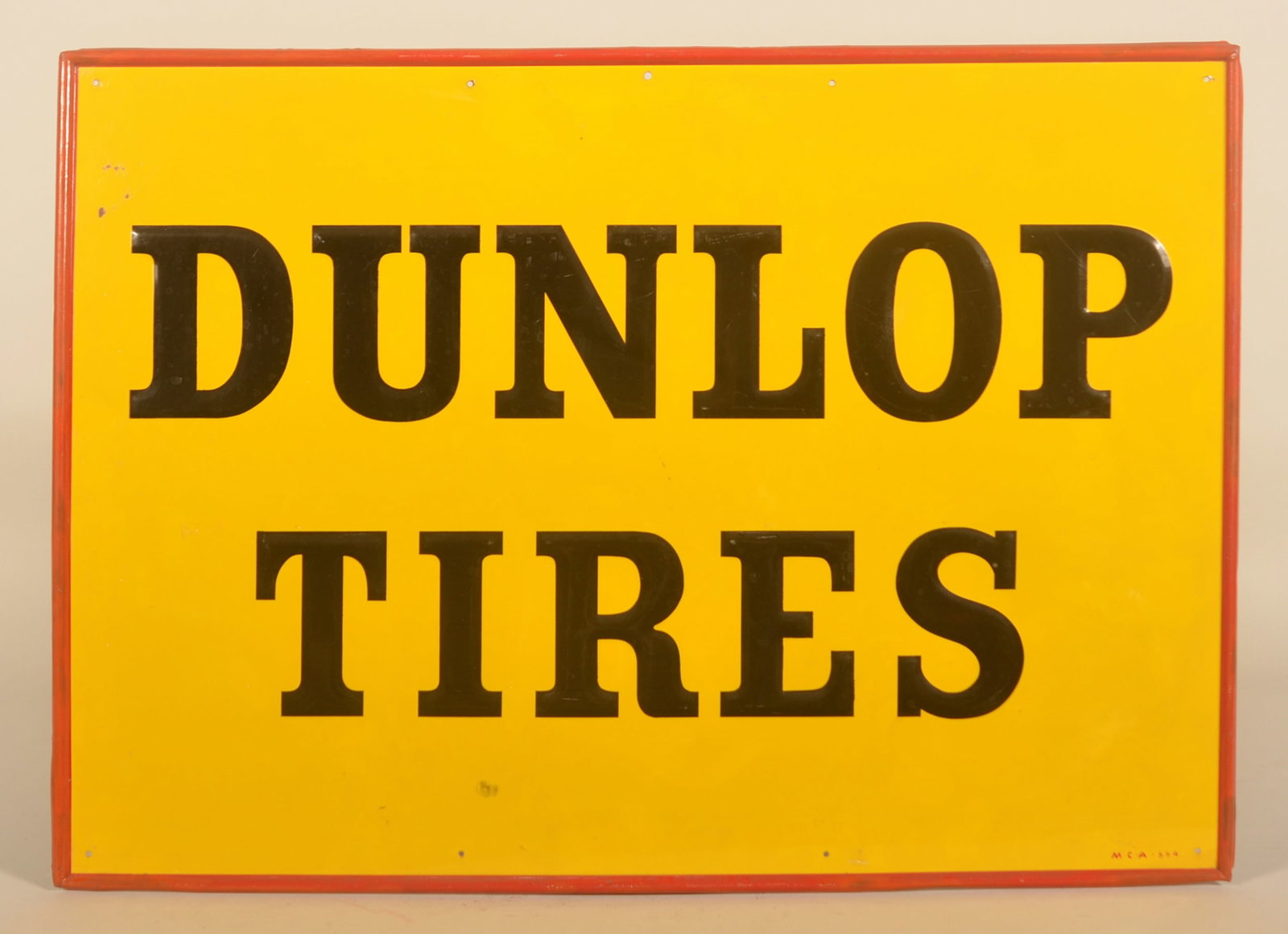 Dunlop Tires Embossed SST Self-Framed Sign: Marked "MCA 884" in lower right corner. Bright colors and good gloss. 19 3/4"H x 27 3/4"W