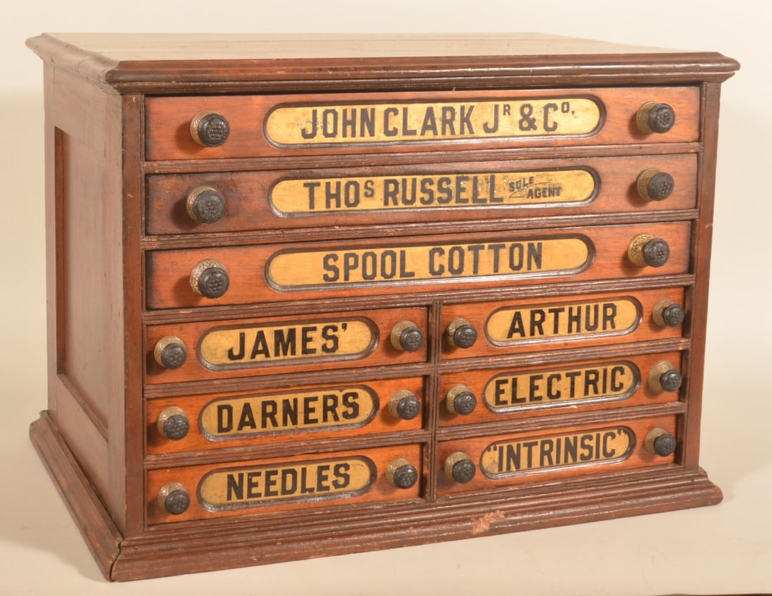 Excellent Clark & Russell 9-Drawer Spool Cabinet: Original finish, handles and labels on this early walnut spool cabinet. Difficult to find variation with additional advertising for darners and needles. 21"H x 28"W x 18 1/2"D