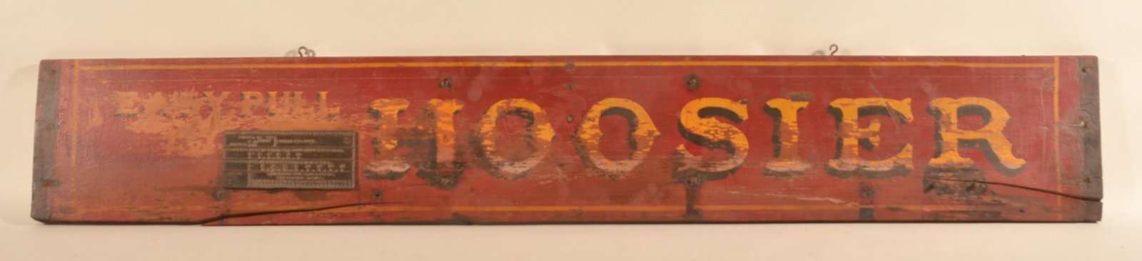 "Easy Pull Hoosier" Painted Harvester Sign: Late-19th century paint-decorated pine board removed from a harvester. Retains the cast iron plaque with directions for use. Original paint. Nice primitive sign for display. 10"H x 66 1/4"W