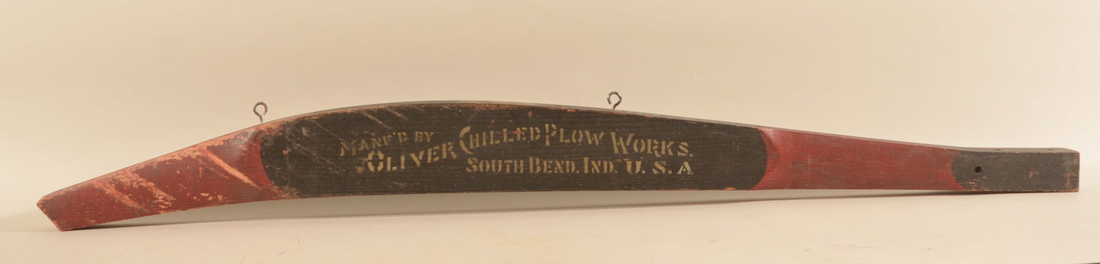 Painted & Stenciled Oliver Plow Works Farm Piece: Wood tongue from a plow retaining original red and black paint, gold stenciling and the maker's label on the top. Wonderful primitive. 6"H x 68 1/4"L