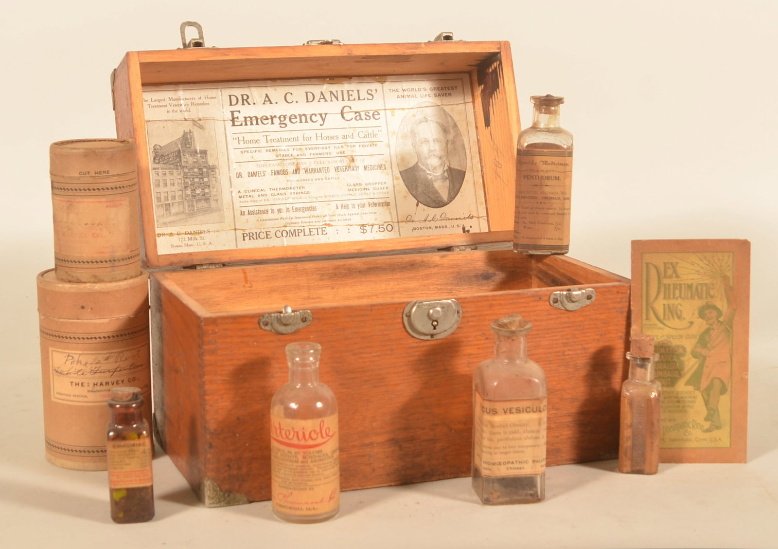 Lg. Dr. Daniels' Veterinary Emergency Stable Case: A larger version of the previous lot with interior label featuring Dr. Daniels advertising his medicines. Box comes with various cork top medicine bottles by different makers. 8"H x 13"W x 6 1/2"D