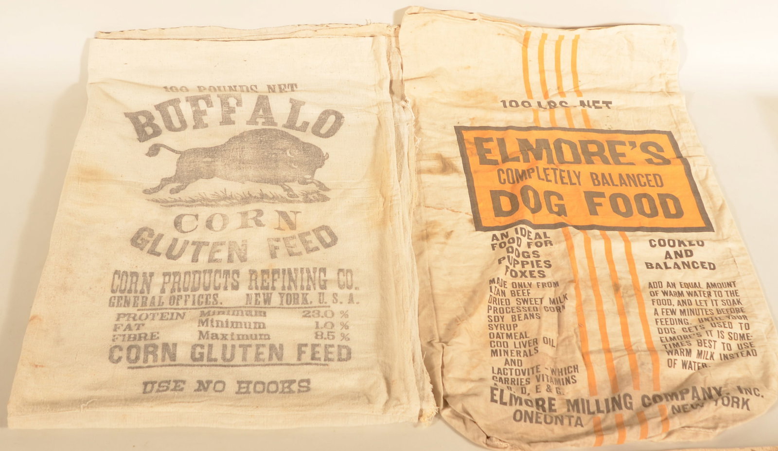 Buffalo Corn Feed & Elmore's Dog Food Feed Sacks: Several Buffalo Corn Feed sacks that were separated and sewn together to make a rough blanket. The Elmore's Dog Food 100-pound sack is from Oneonta, NY. Buffalo blanket, 87"H x 62"W