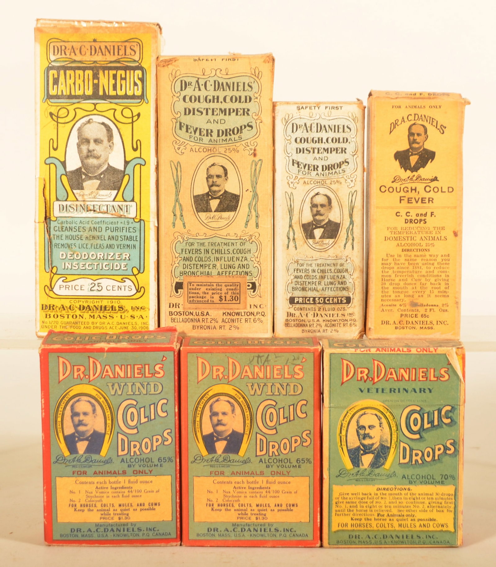 Dr. Daniels' Vet Remedies Bottles & Boxes: Seven packages including two "Wind" Colic Drops, Colic Drops, two different size Cough/Cold/Distempers, later version of the CCF, and a large Carbo-Negus. Tallest, 6 1/2"H