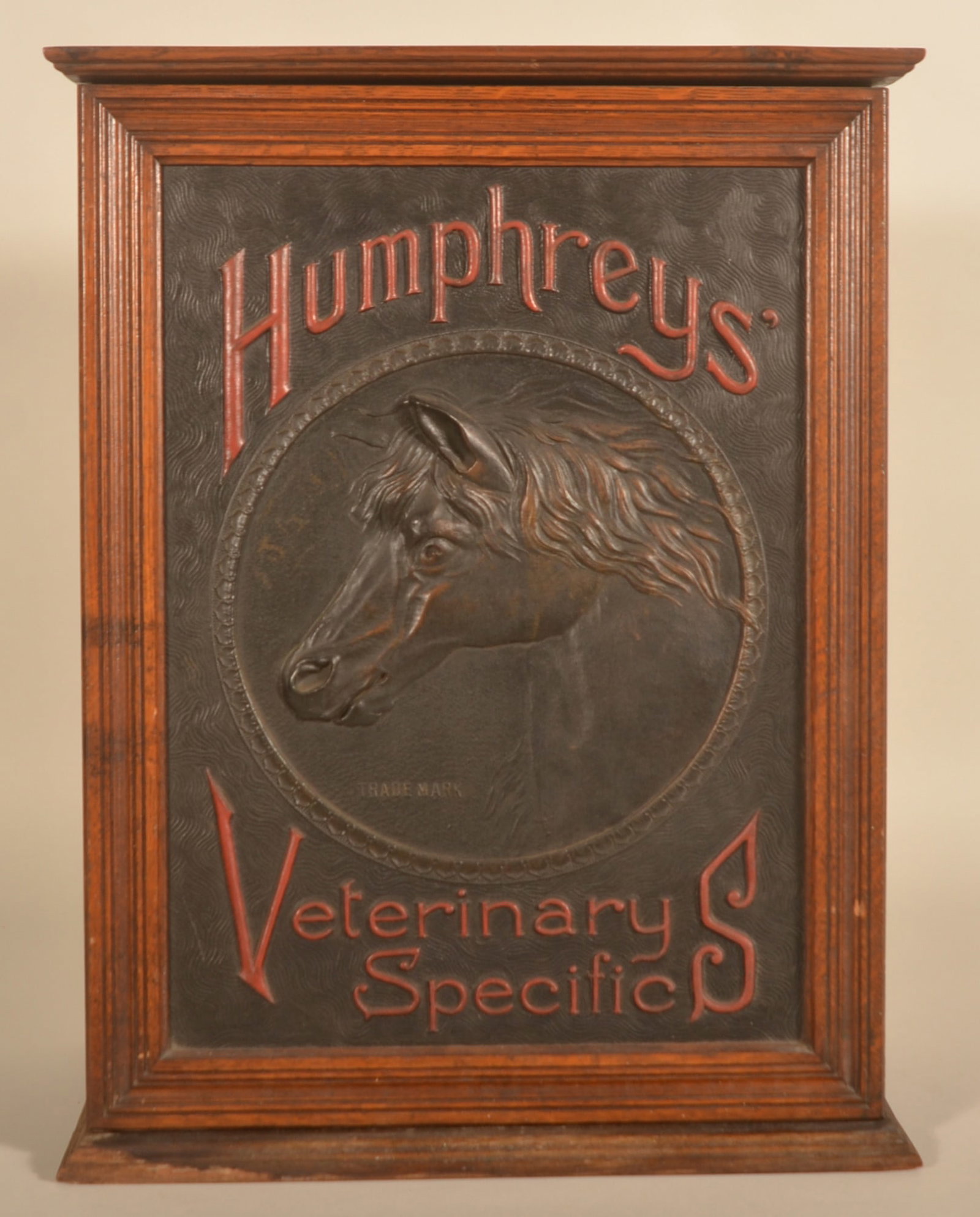 Humphreys Veterinary Specifics Display Cabinet: Difficult to find veterinary version featuring a graceful horse with flowing mane made out of embossed composite material. The cabinet is in the original finish. No touchups to the door panel. The red