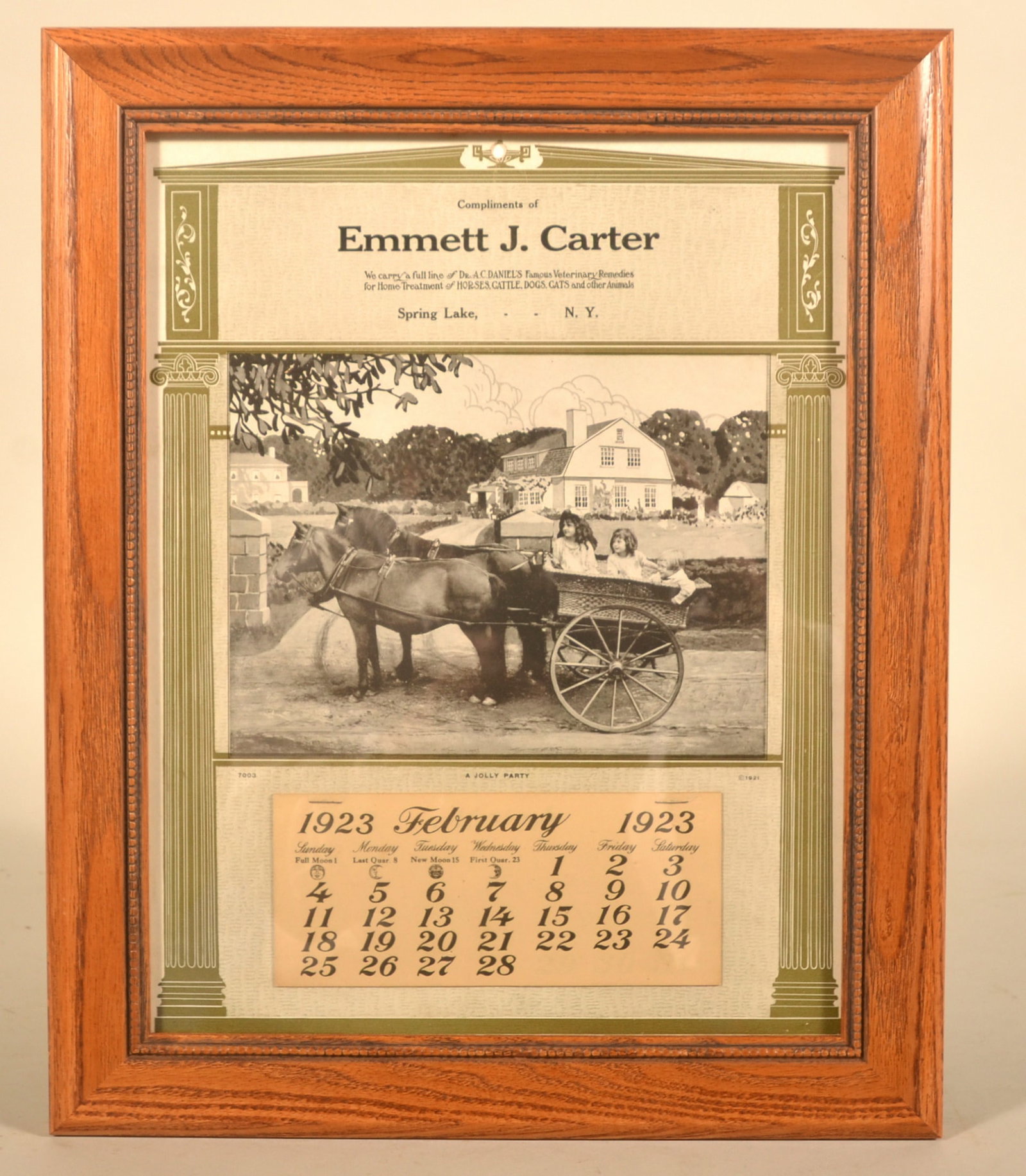 Dr. Daniels Veterinary Advertising 1923 Calendar: Framed calendar compliments of Emmett J. Carter in Spring Lake, NY, featuring an image of kids riding in a cart drawn by a team of horses. Partial calendar pad starting in February. Advertising for