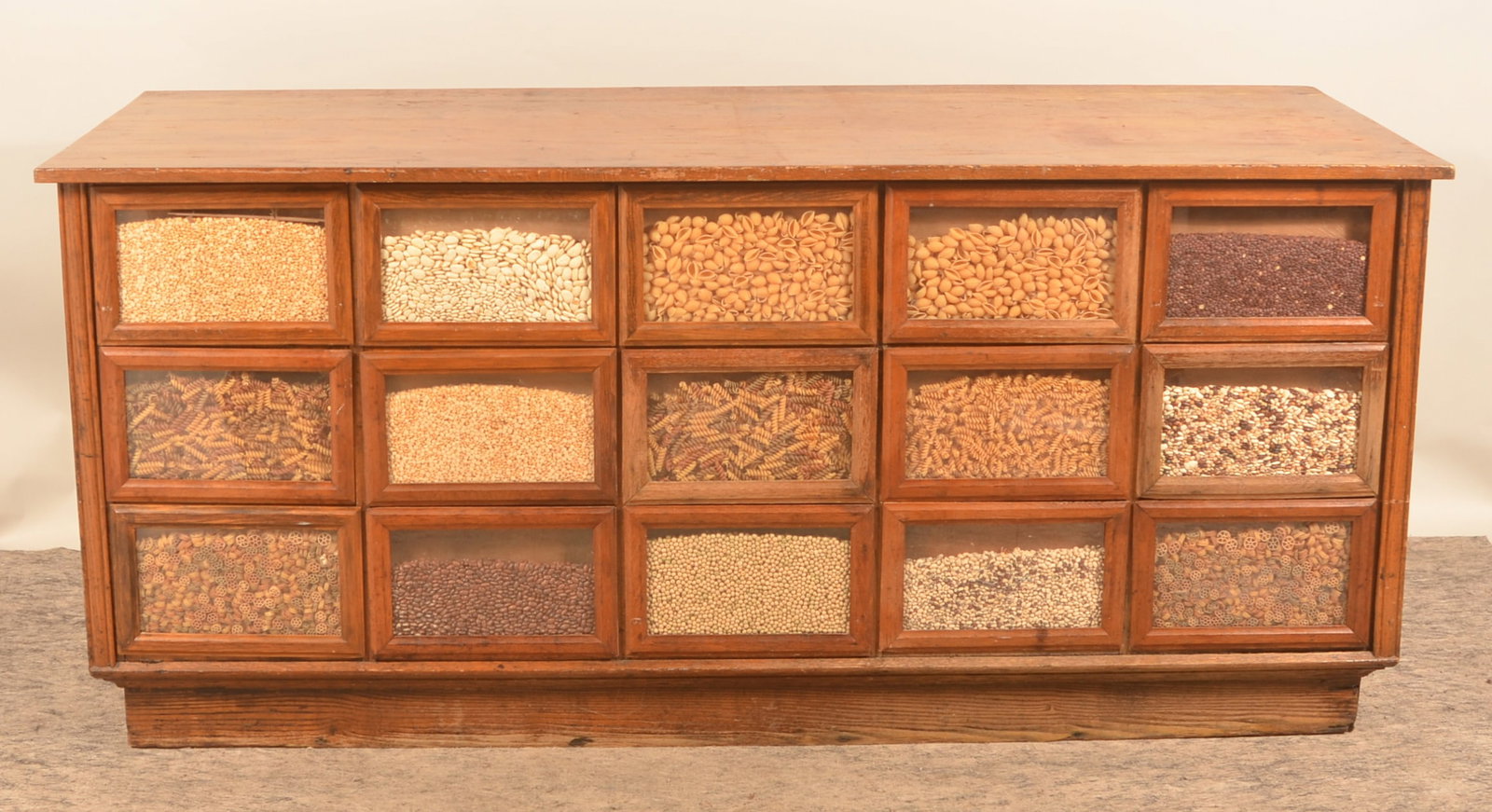 Excellent Antique General Store Seed Counter: Great-size seed counter with original finish and 15 glass fronts for display. Not cut down, not marked, but possibly by Sherer. Original drawer pulls and product labels. Provenance: The collection of 
