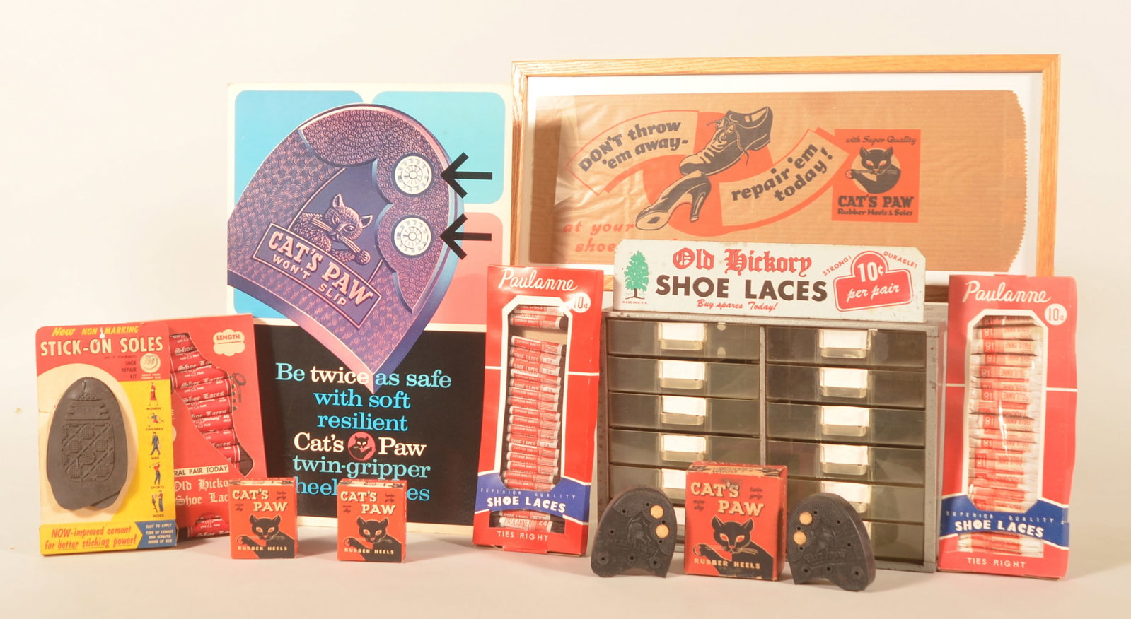 Cat's Paw Shoe Sign & Old Hickory Lace Display: Cardboard easel-back sign for Cat's Paw, along with a framed Cat's Paw paper advertising bag and three unopened boxes of Cat's Paw product. Included in the group is a metal with plastic pull-out