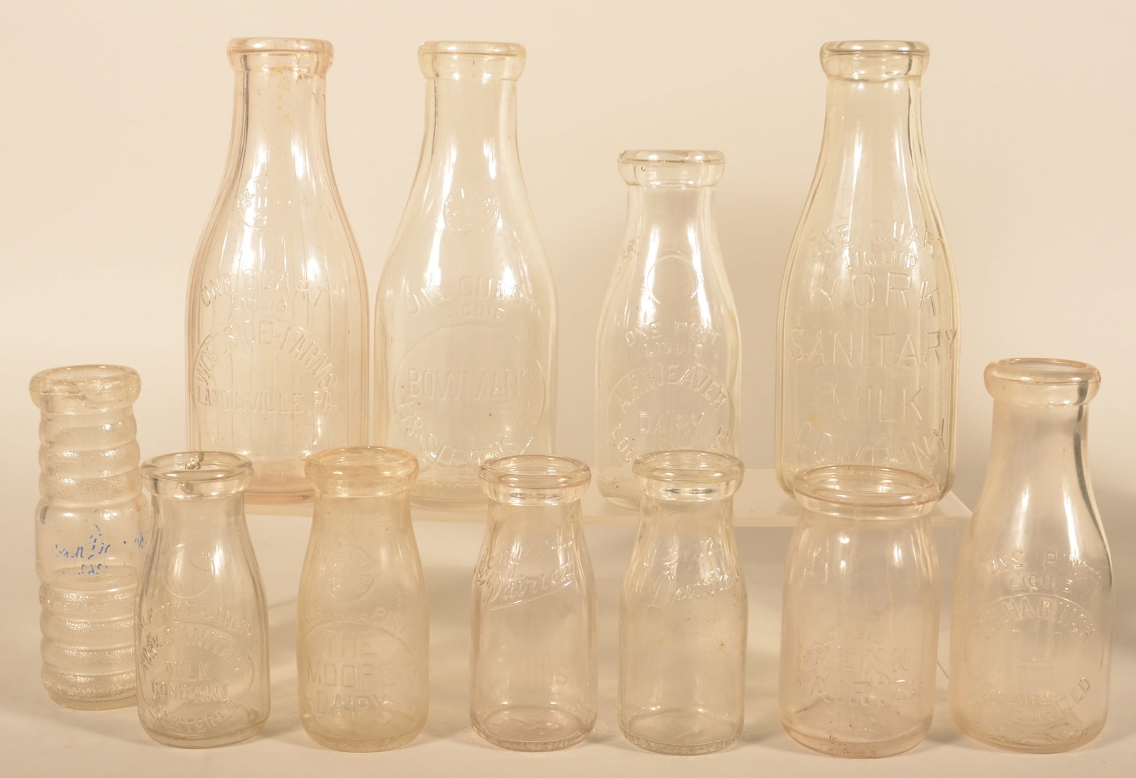 Group of Vintage Pennsylvania Milk Bottles: Eleven bottles total in this group including a 1/2-pint Moore Dairy (chip in rim), pint C.H. Harnish (milk glassing to bottle), A.H. Weaver Locust Grove (chip in rim), Levengood Dairies, Bowman's on S