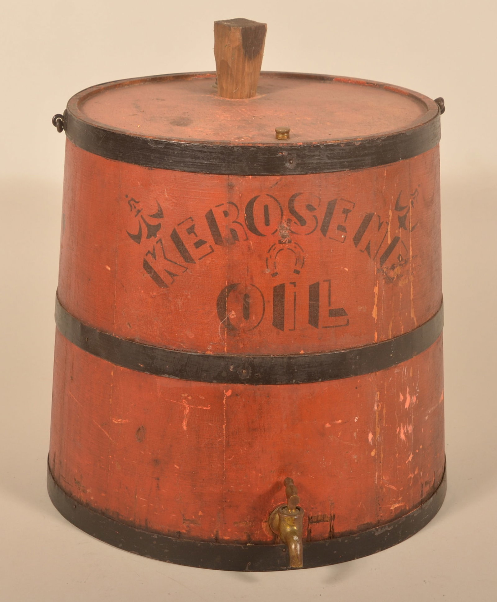 Red Painted & Stenciled Wood Kerosene Dispenser: General store bail-handled wood bucket with brass spigot stenciled on front and on top. Painted black metal bands. Provenance: The collection of Russell and Darlene Snyder. 14"H x 12 1/2"D