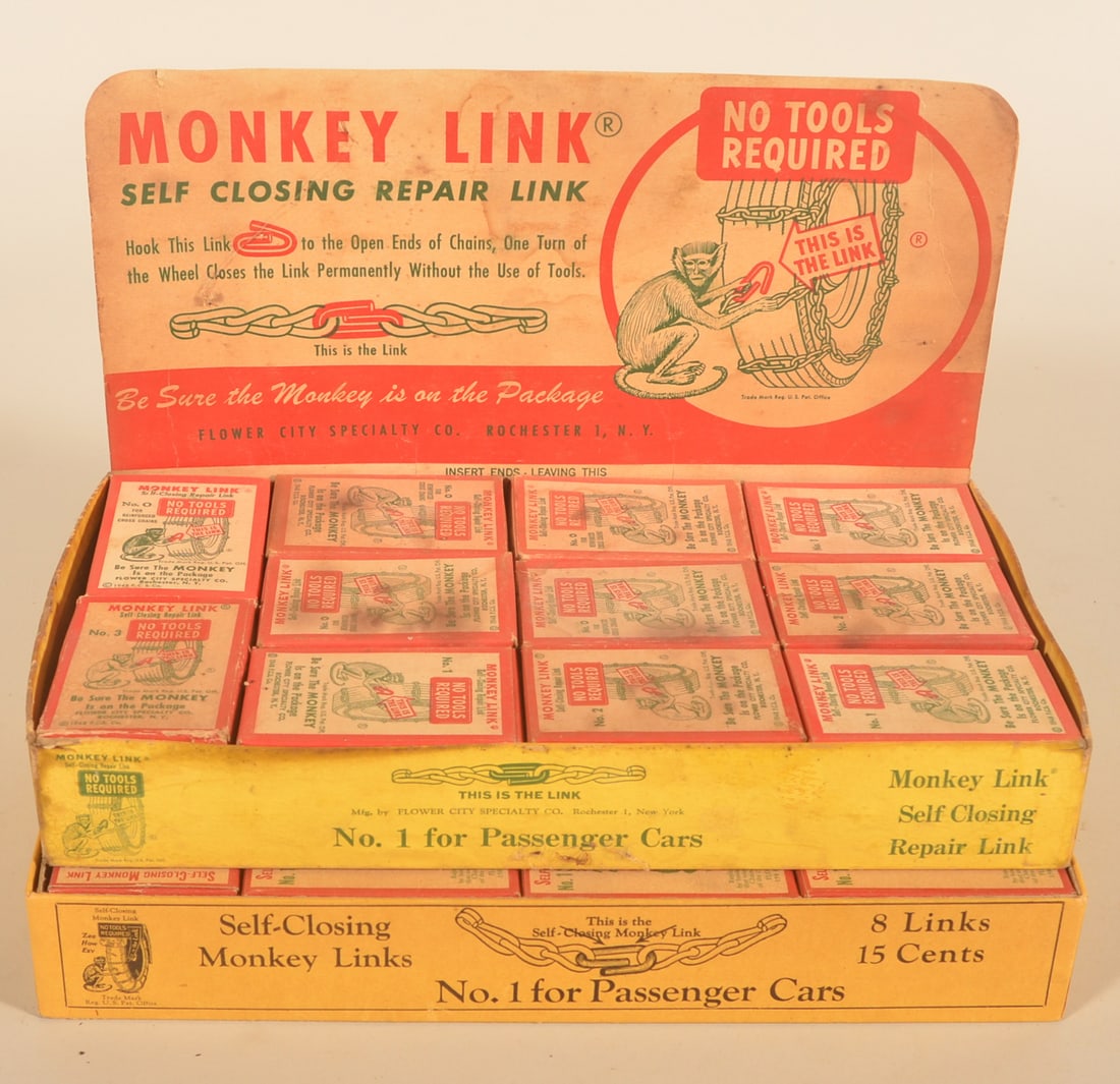 Two NOS Boxes Monkey Links Tire Chain Displays: One complete box with cardboard store display featuring the monkey putting a link on a snow tire. Second complete box with cardboard lid that doesn't have advertising (splits at end of lid). From the 