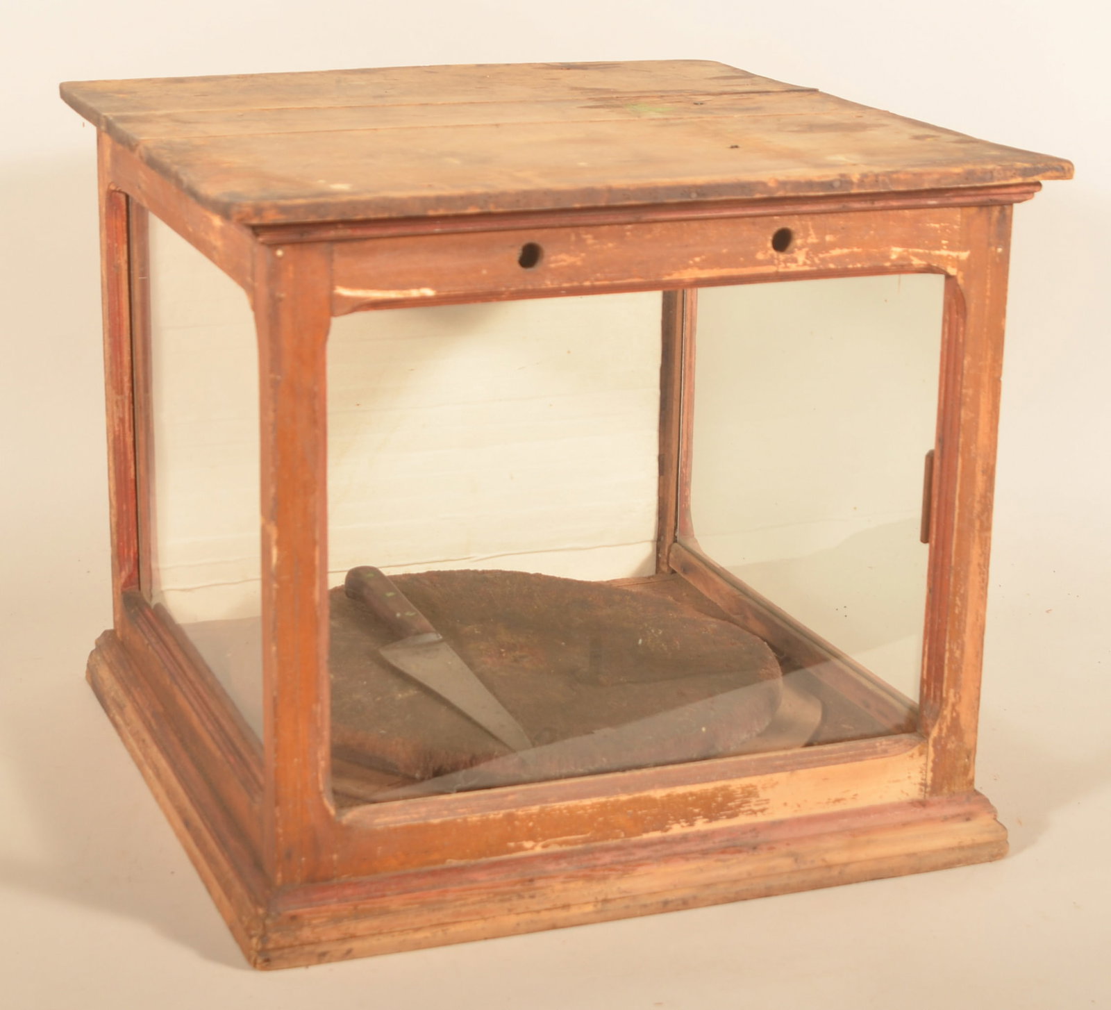 General Store Cheese Display Case: Antique display case with rotating display table, roll-up rear door stenciled "Bronze Medal" and original finish. Provenance: The collection of Russell and Darlene Snyder. 19"H x 21 1/2"W x 21"D