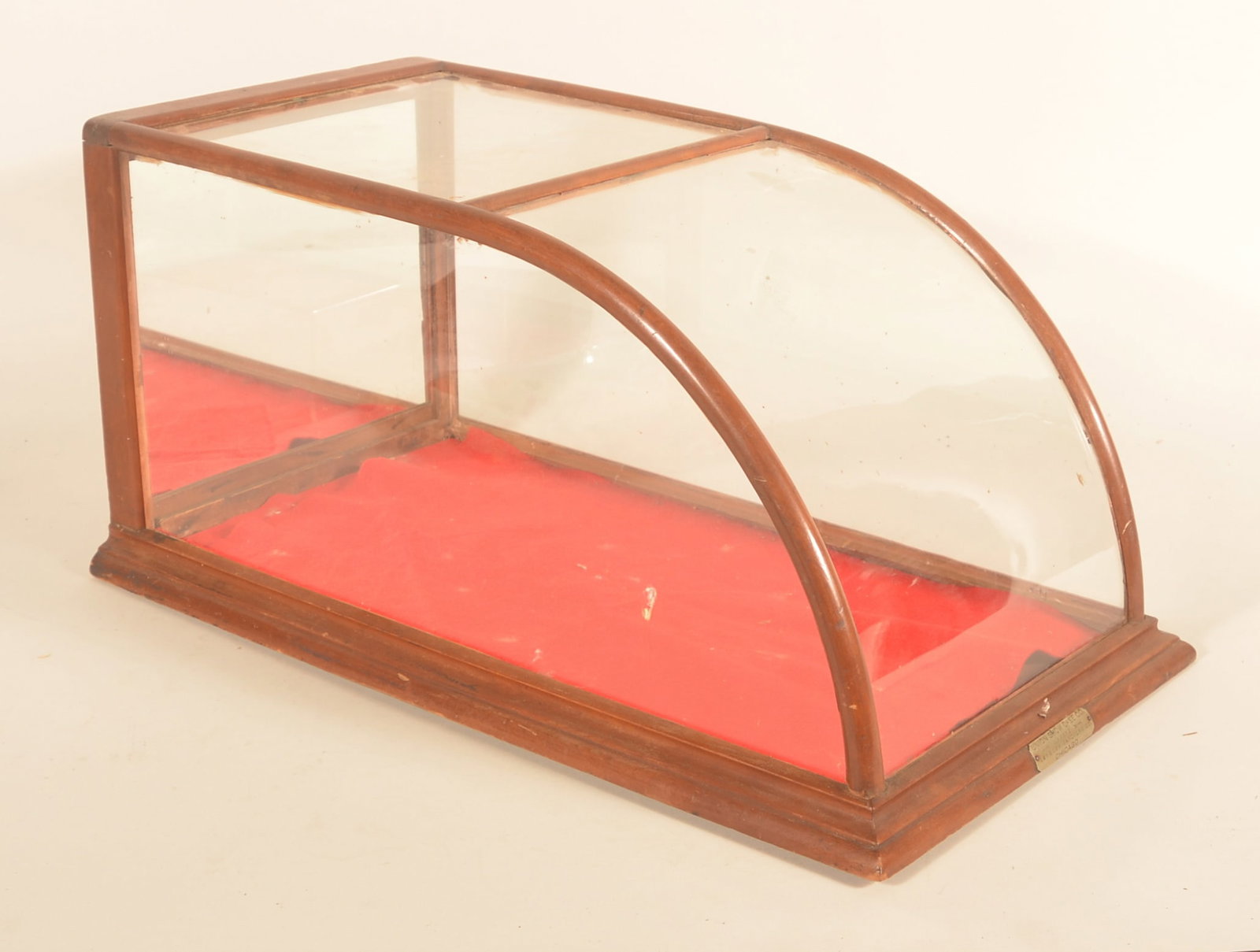 Antique Curved Front Union Showcase: Deep, mirrored door display case, wood frame with nickel-plated maker tag on front from the Union Show Case Co. in Chicago, IL. Provenance: The collection of Russell and Darlene Snyder. 12 3/4"H x