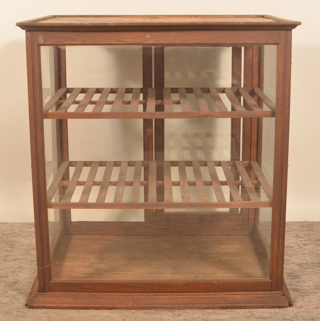 Large General Store Bakery Display Case: Two sliding doors bakery case with two interior shelves, oak frame and original glass. Stamped on top "Braun Bros & Co". Provenance: The collection of Russell and Darlene Snyder. 31 1/4"H x 35 1/4"W