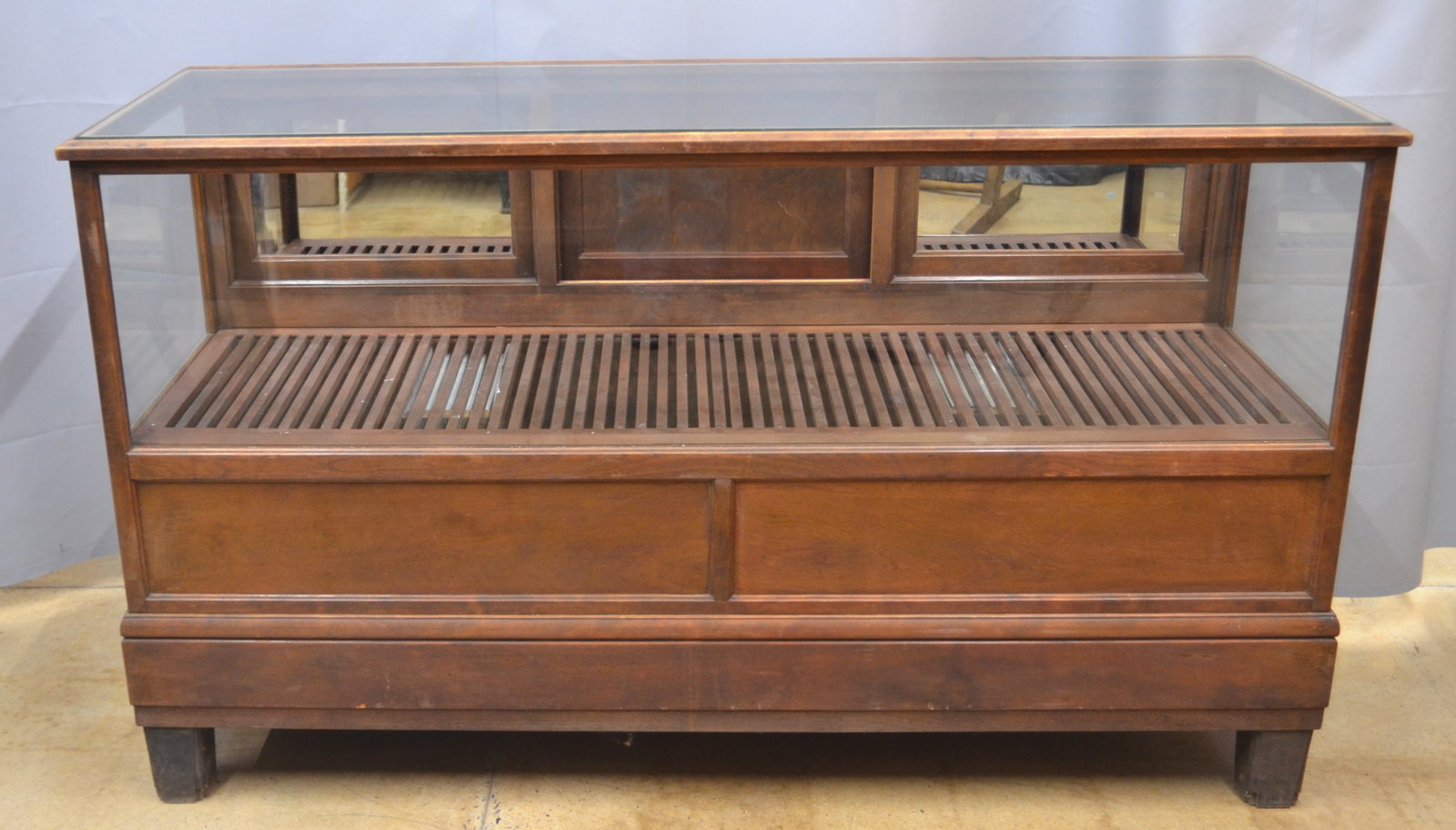 Antique Cigar Store Display Case: Ca.1910-1920. Beveled glass top, recessed panel front and sides, three tilt-out doors over two slide doors. Case has original pull out humidor drawers and original ventilated rack. Very nice example.