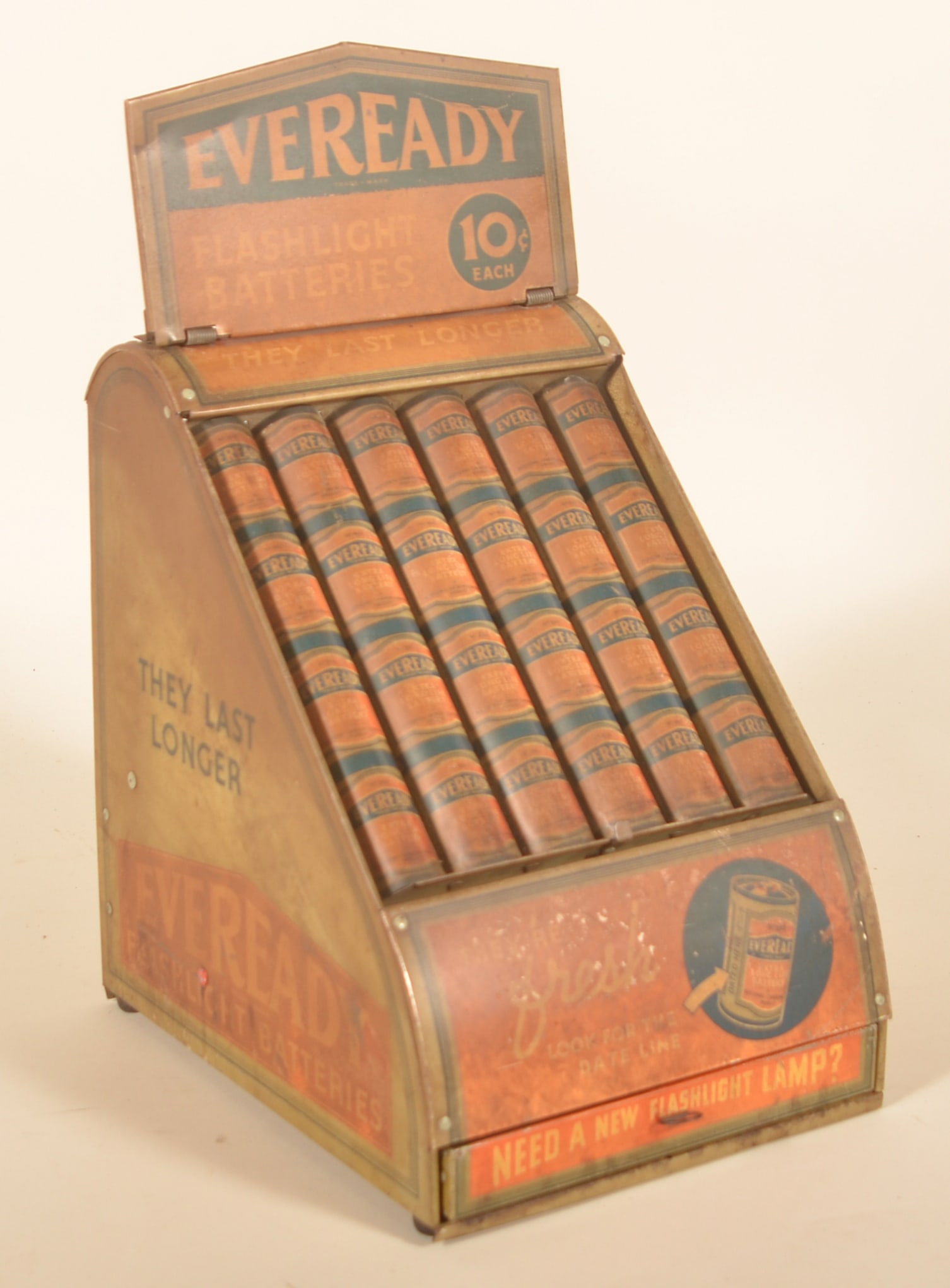 Eveready 10 Cent Flashlight Battery Store Display: Figural tin display with bottom drawer and original product in the rear. Marquee folds down to reveal a test light bulb and areas for batteries to be placed. Provenance: The collection of Russell and
