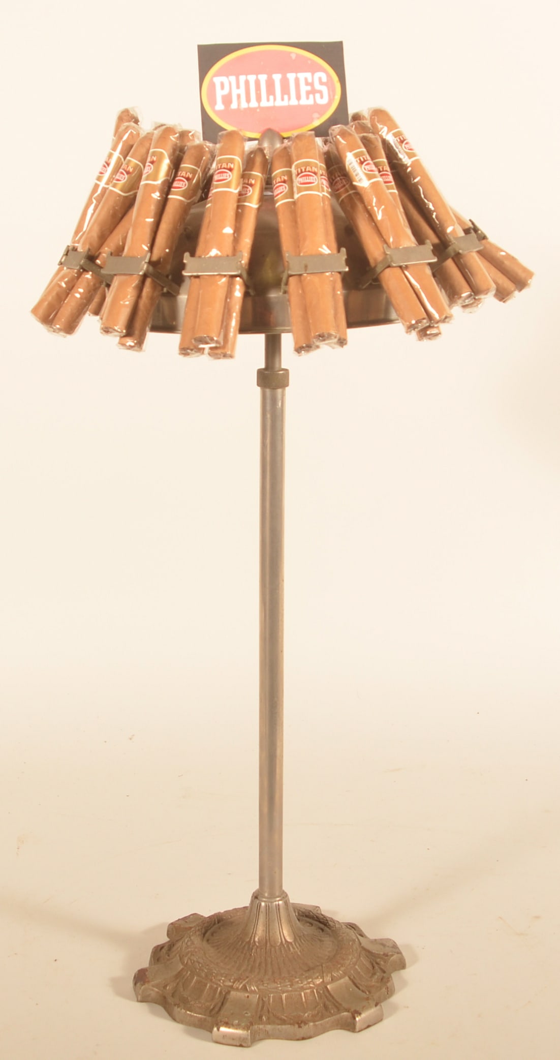 Vintage Tall Figural Chrome & Steel Cigar Display: Cast base, chrome pole and umbrella-shaped metal display with cigar holders and an acorn finial that would hold a cardboard display. This display is set up for Phillies cigars. Very nice display.