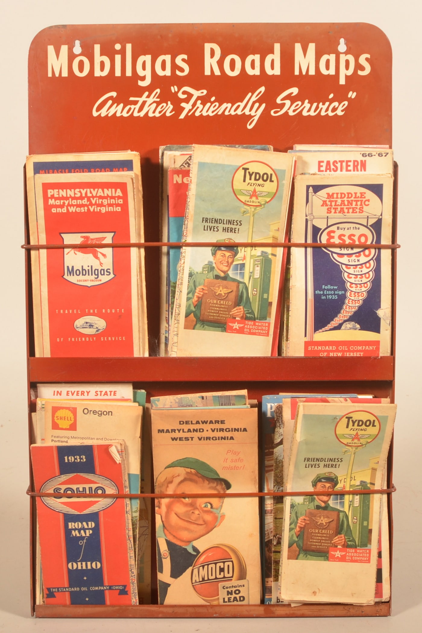 Mobilgas Hanging Gas Station Road Map Display: 1960s vintage hanging metal display filled with road maps from various Gas companies including Sohio, Tyrdol, Esso and Mobilgas. Provenance: The collection of Russell and Darlene Snyder. 24"H x 14