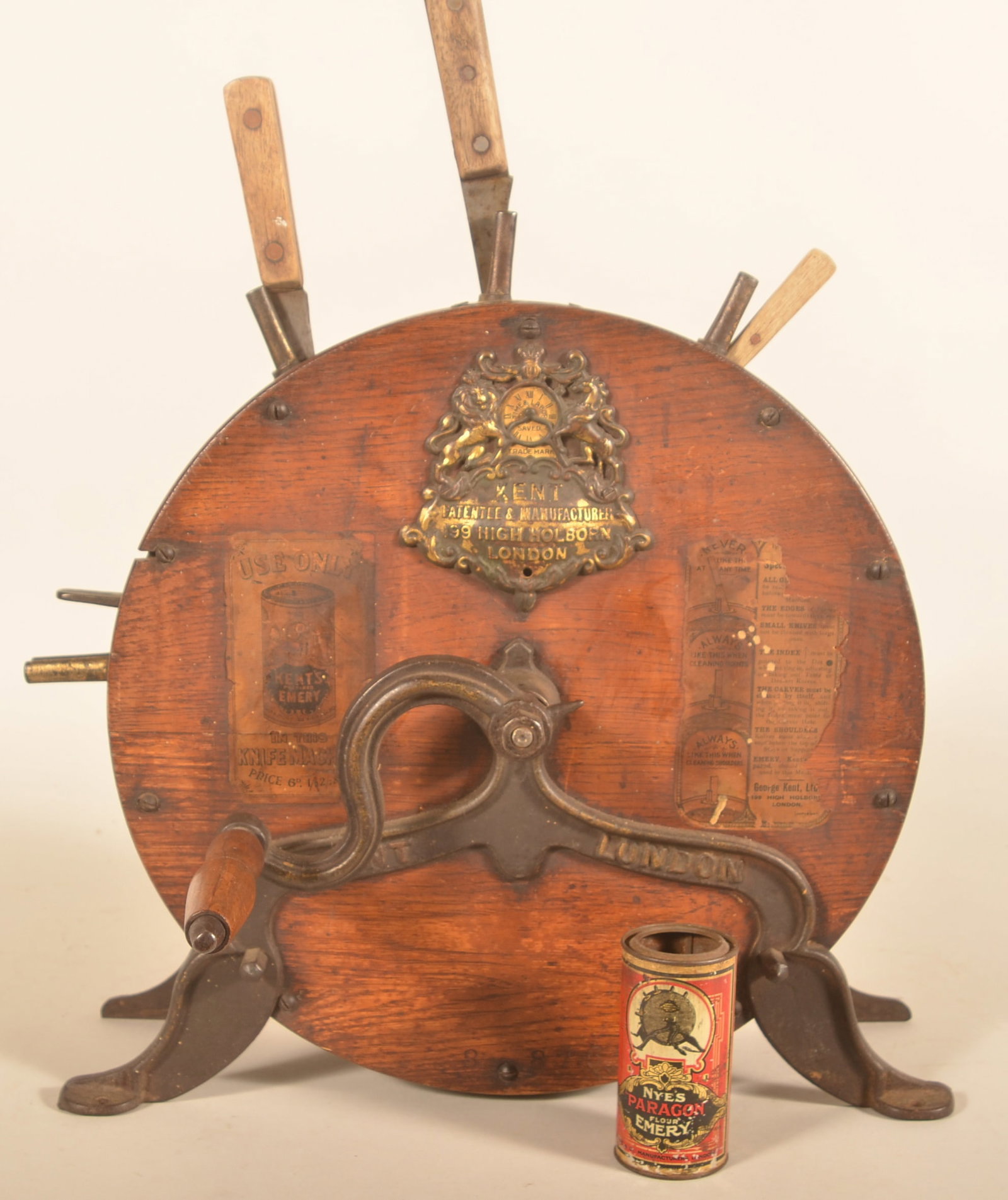 Kent's Patent Knife Sharpening & Cleaning Machine: Kent's patent rotary disc hand-operated knife sharpening and cleaning machine from London, England. Original partial labels, cast iron embossed base, pot metal Kings Arms logo. Provenance: The collect