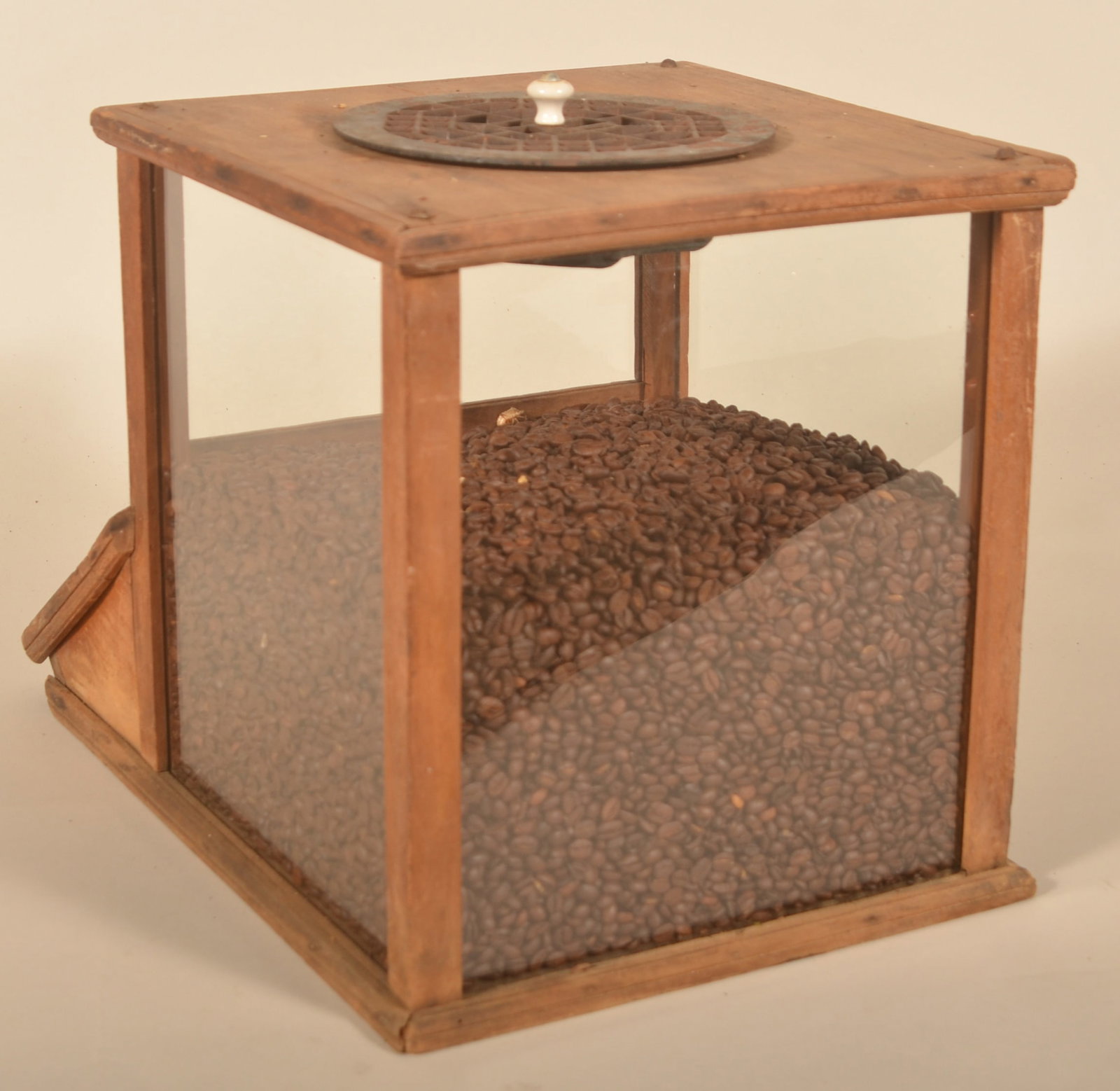 Early Primitive Coffee Bean Countertop Display: Wood and glass display with lift lid in front. Cast iron vent on top opens and closes to allow air to circulate. Wonderful primitive look. Provenance: The collection of Russell and Darlene Snyder. 13 
