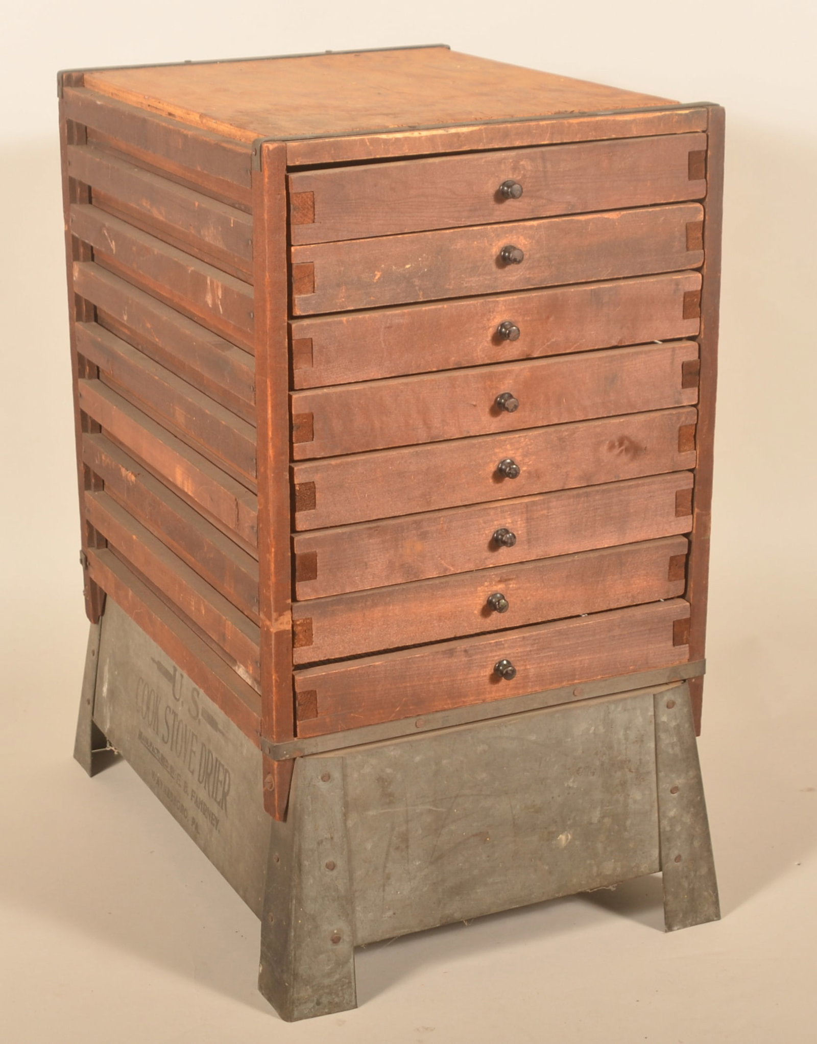 Antique US Cook Stove Food Drier: Made by Fahrney from Waynesboro, Pa. Eight wood drawers with screened bottoms on top of a galvanized metal base. Provenance: The collection of Russell and Darlene Snyder. 25 1/2"H x 14 1/2"W x 21"D