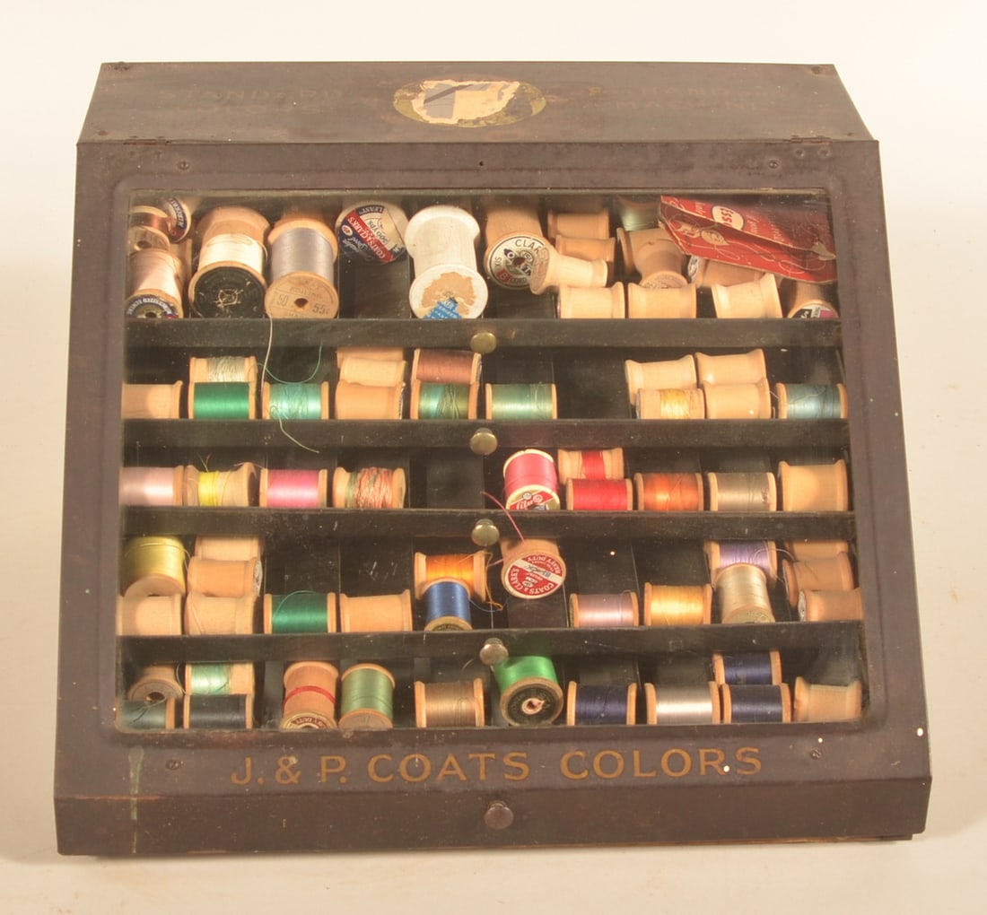 J&P Coats Metal & Glass Store Counter Display: 1920s counter display. Front lifts to gain access to spools of cotton. Provenance: The collection of Russell and Darlene Snyder. 10"H x 15 1/4"W x 13 1/4"D
