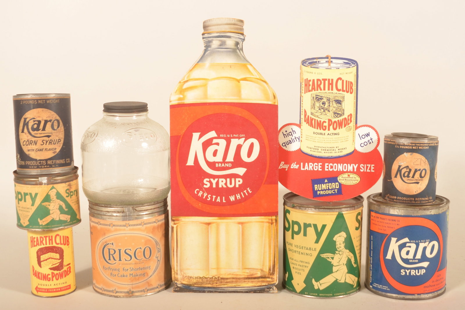 Karo, Spry, Hearth Club & Crisco Kitchen Items: Nice group of kitchen-related advertising pieces. A Hearth Club double-sided cardboard fan pull and tin, three Karo paper label tins and a cardboard easel-back Karo counter display, glass embossed Cri