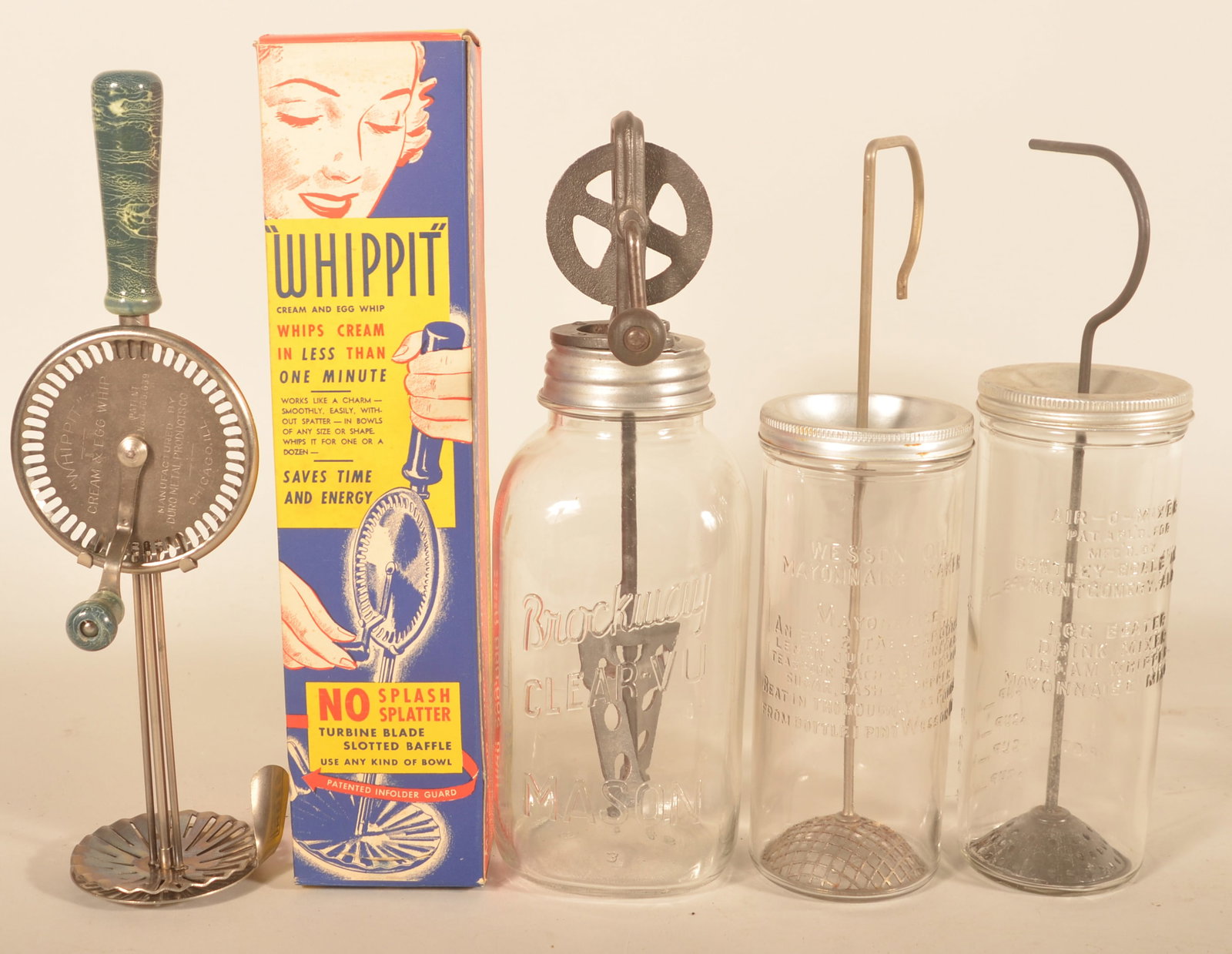 Group Vintage NOS Kitchen Hand Tools: Four items total. "Whippit" hand mixer in the original box, two glass Mayonnaise makers, and a glass Brockway Clear-Vu butter churn. Provenance: The collection of Linda and the late Ed Althouse. Whipp