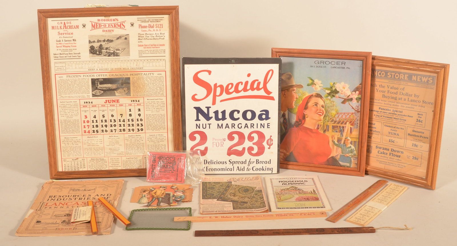 Collection of Lancaster, PA Vintage Advertising: Huber dairy flyswatter, two Graybill pencils, Metzler mower matchbook, framed paper grocer ad from Duke St, Lion coffee cut-outs in envelope, shrinkwrapped Nucoa pricing sign, Rocky Springs tickets, 1