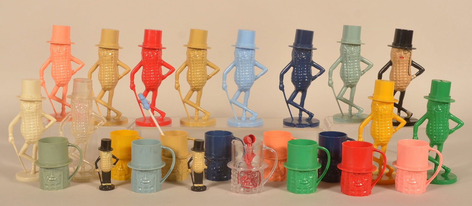 Large Collection Planter's Peanut Plastic Pieces: Twelve different plastic full-figure Mr. Peanut banks, eleven plastic Mr. Peanut drinking mugs, two plastic straws with Mr. Peanut at the top, plastic measure, and plastic Mr. Peanut salt and pepper.