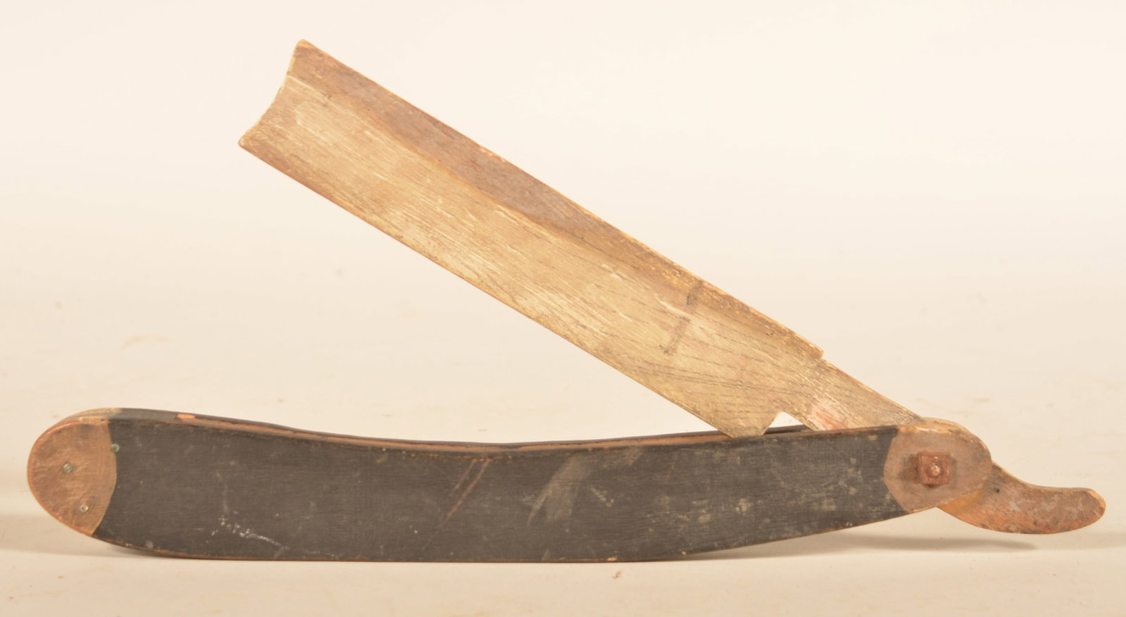 Small Carved Wood Straight Razor Painted Folk Art: Nice piece of painted folk art for possible use in a store. Ca. 1920s. Straight razor twists out of the holder. Original black and white paint with great surface. 14"L