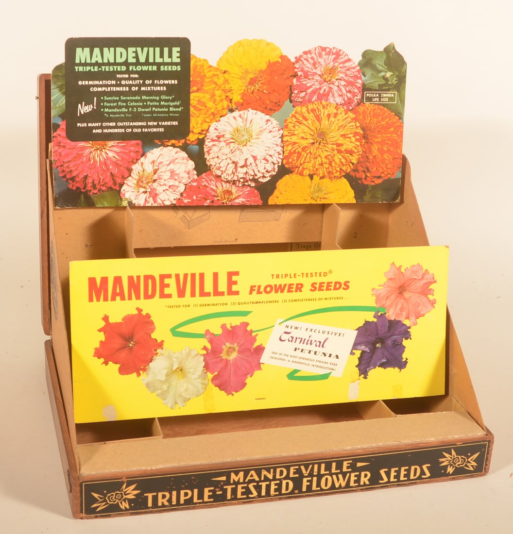 Large Mandeville Seed Pop-Up Display: Oak display box with paper label on front. Lid opens and the cardboard pieces are complete to set up a seed display. Unused condition. Provenance: The collection of Russell and Darlene Snyder. 4 1/2"H
