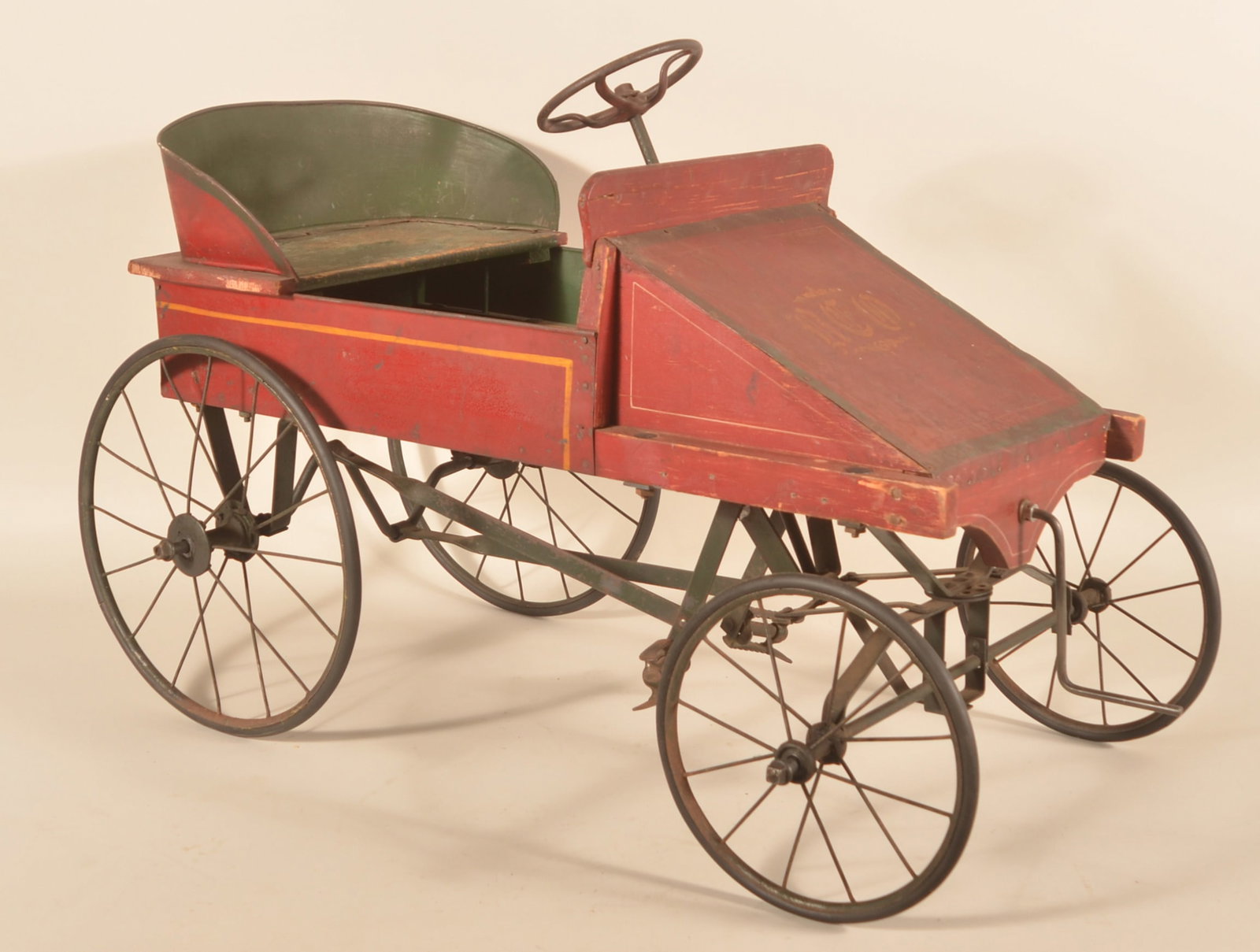 Rare Ca. 1910 "REO" Original Paint Pedal Car: REO motor car company was based in Lansing, MI from 1905-1975 and was the motivation for the name of the rock band REO Speedwagon. This pedal car has a metal body, seat and hood. The front fenders, bo