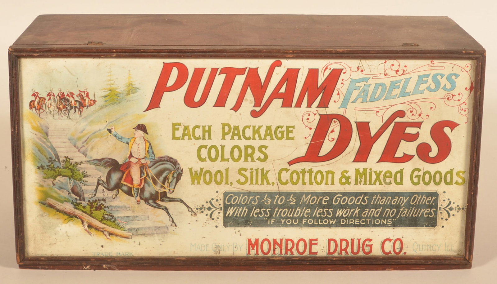 Putnam Fadeless Dyes Cabinet: Wood dovetailed cabinet with paper advertisements on both sides of the lift door and a tin ad on the reverse. Cabinet in the original finish. Provenance: The collection of Russell and Darlene Snyder. 