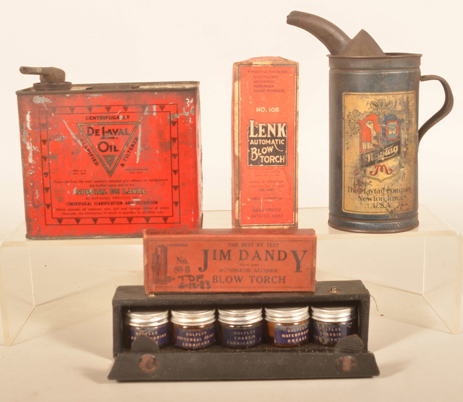 Group of Antique Country Store Advertising Items: Nice group of five items including a Maytag oil can, De-Laval 1/2-gallon oil can with spout, Jim Dandy blowtorch in the box, Lenk blow torch in the box and a Gulflex petroliana salesman's sample kit w