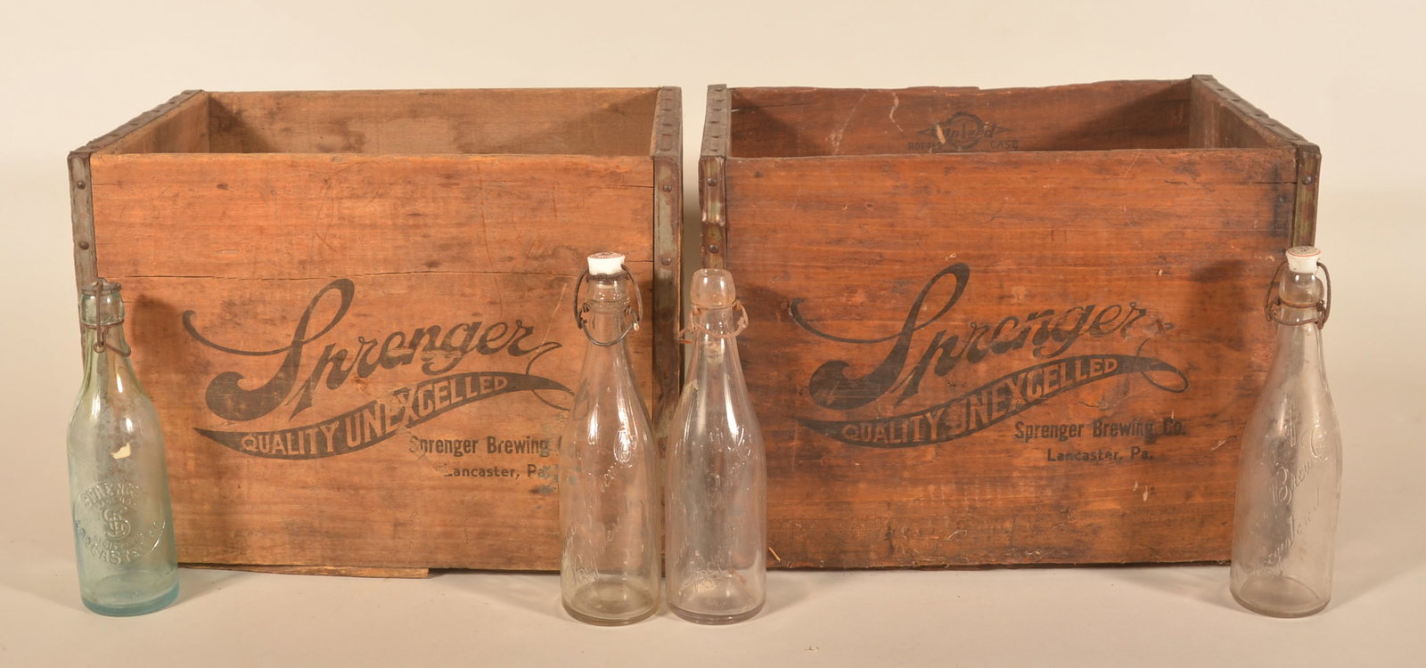 Group Sprenger Brewery Crates & Beer Bottles: Brewed in Lancaster, Pa., this group consists of two Red Rose wood crates and four beer bottles. Two of the bottles with nice, logoed porcelain caps. Crates, 12 1/2"H x 12 1/2"W x 17"D