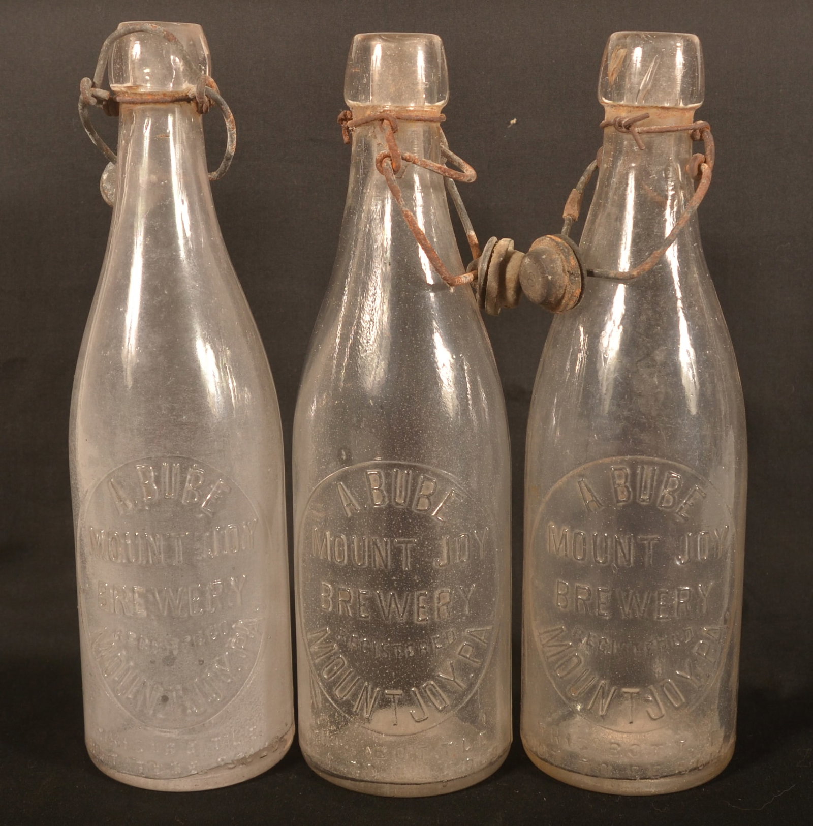 Three "A.Bube" Brewery Mount Joy, PA Beer Bottles: Clear glass beer bottles from the historic A.Bube Mount Joy Brewery. The building is still in use today as a restaurant. 9 1/2"H
