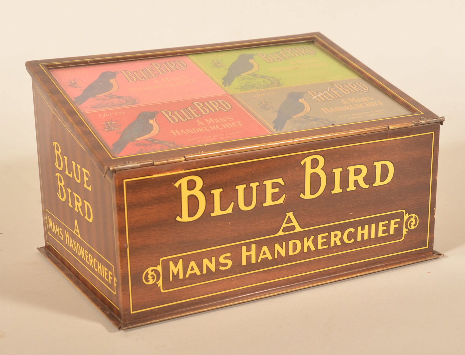 Blue Bird Handkerchief Store Counter Tin Display: Great colors and graphics. Slant front with glass lifts open to display some NOS product still inside. Excellent example. Provenance: The collection of Russell and Darlene Snyder. 6 3/4"H x 11 3/4"W x