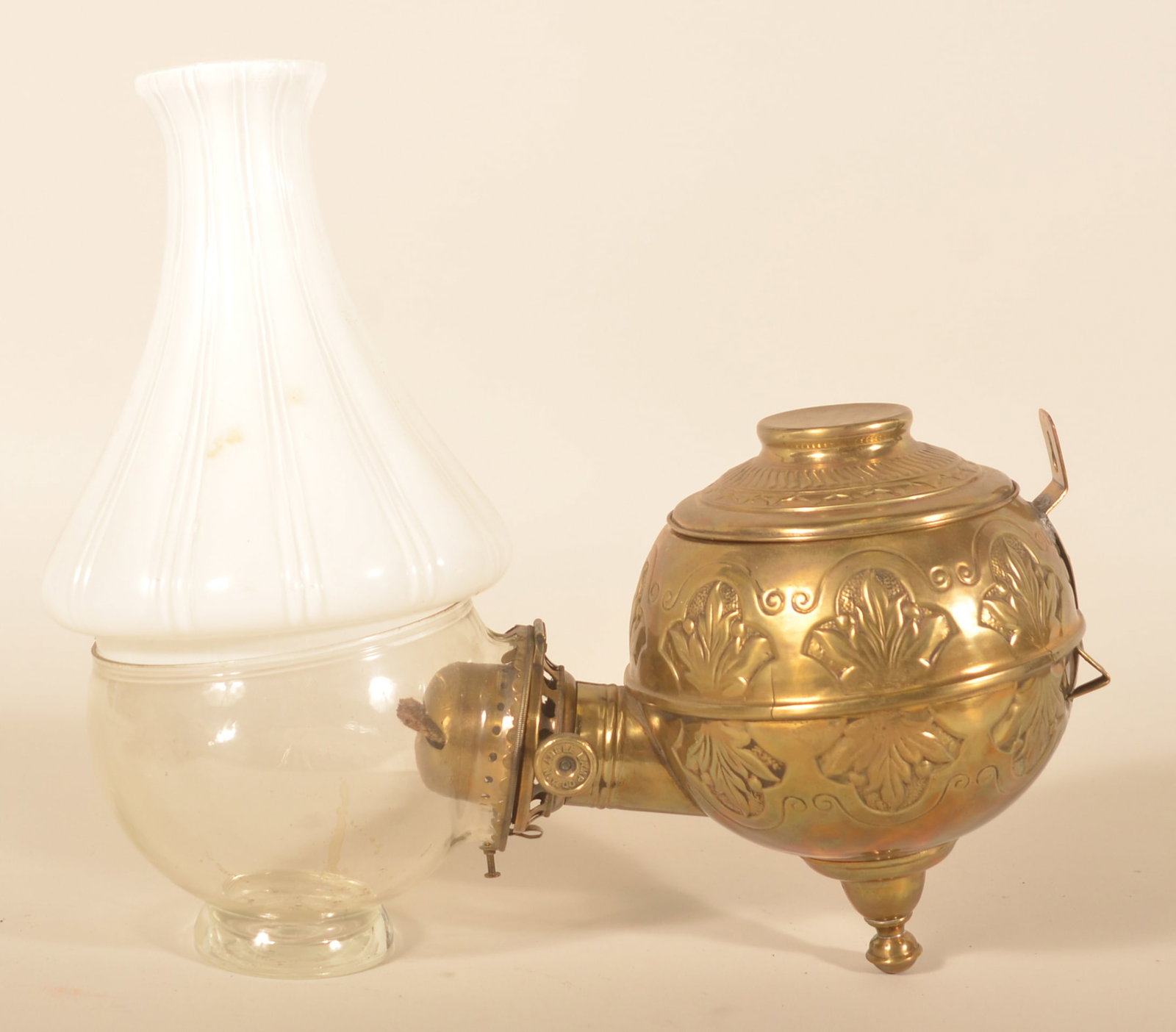 Brass Single-Arm Angle Lamp: Late-19th-century oil lamp with embossed tank. Marked "The Angle Lamp Co NY" on the top of the tank. Original glass, 2-part globe. Provenance: The collection of Russell and Darlene Snyder. 14 1/2"D
