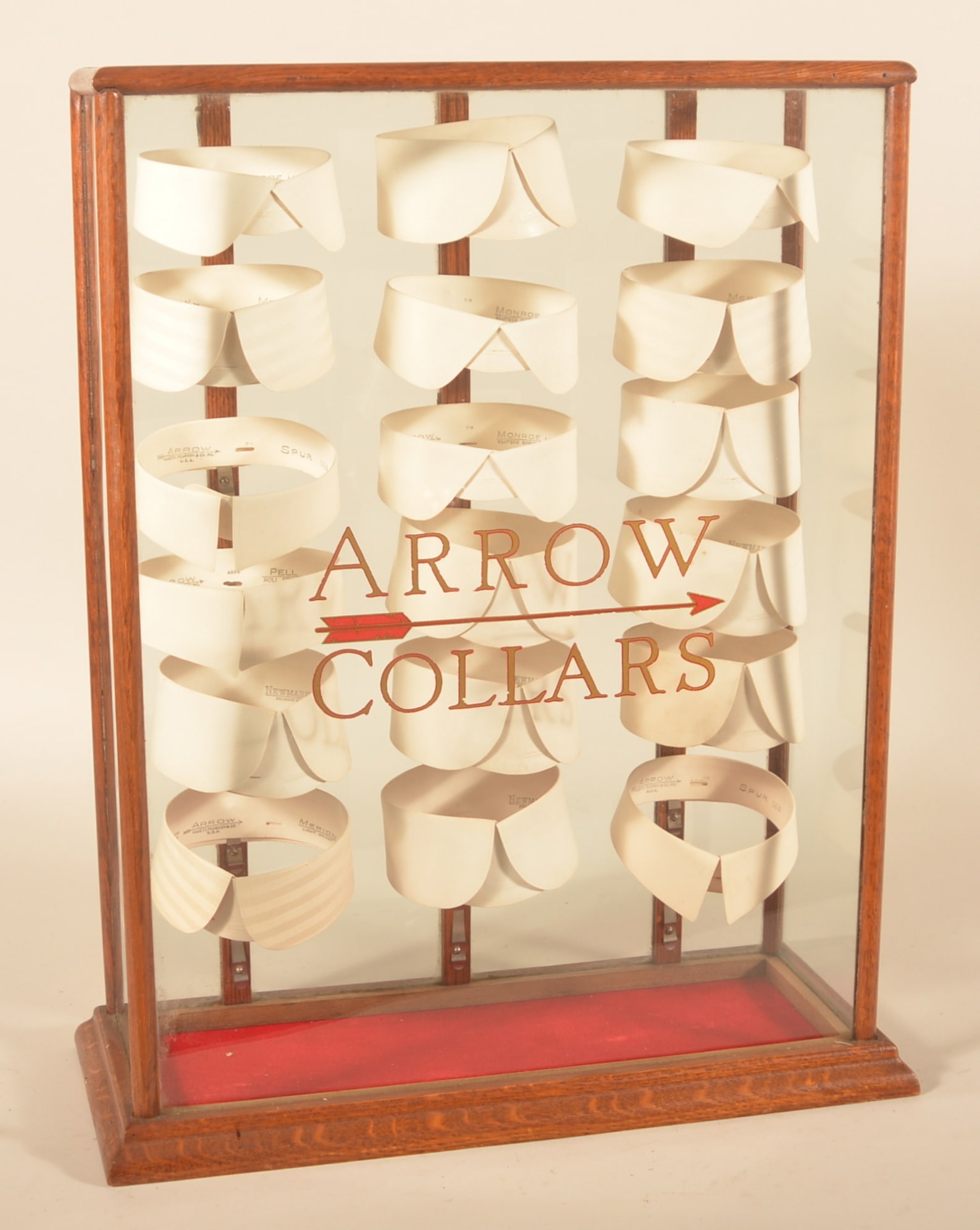 Excellent Arrow Collars Display Case: Oak and glass case with original reverse-applied lettering and original store stock. Excellent example. Complete display. Provenance: The collection of Russell and Darlene Snyder. 25 1/2"H x 20 1/2"W