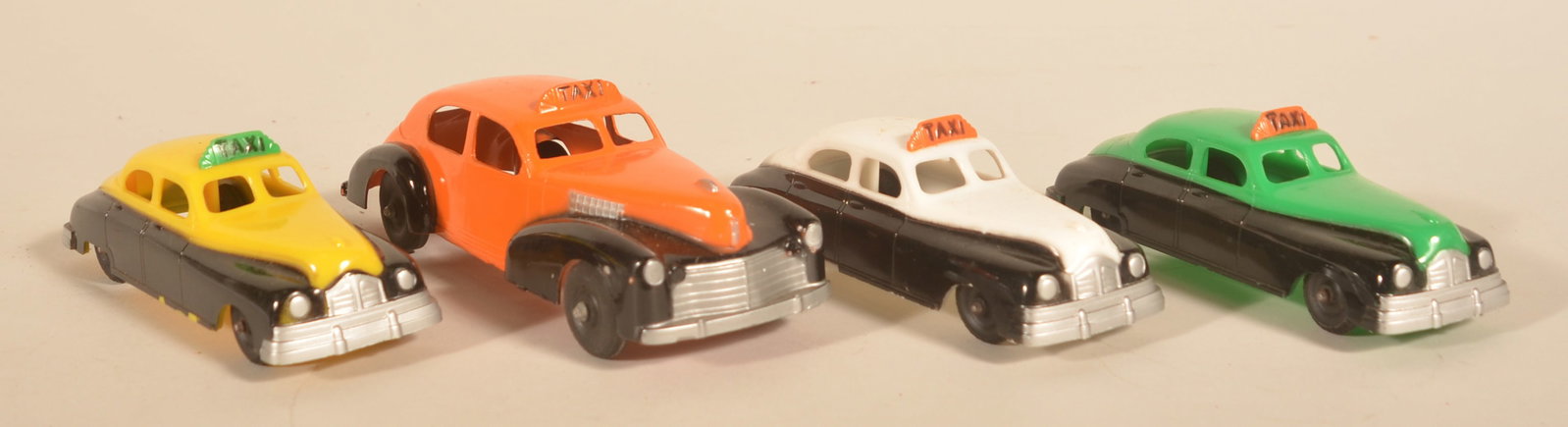 Hubley Kiddie Toy Plastic & Metal Taxi Cars: Excellent NOS Hubley cars including one large metal taxi in orange and black and three plastic taxis. Four total. Large taxi, 7"L