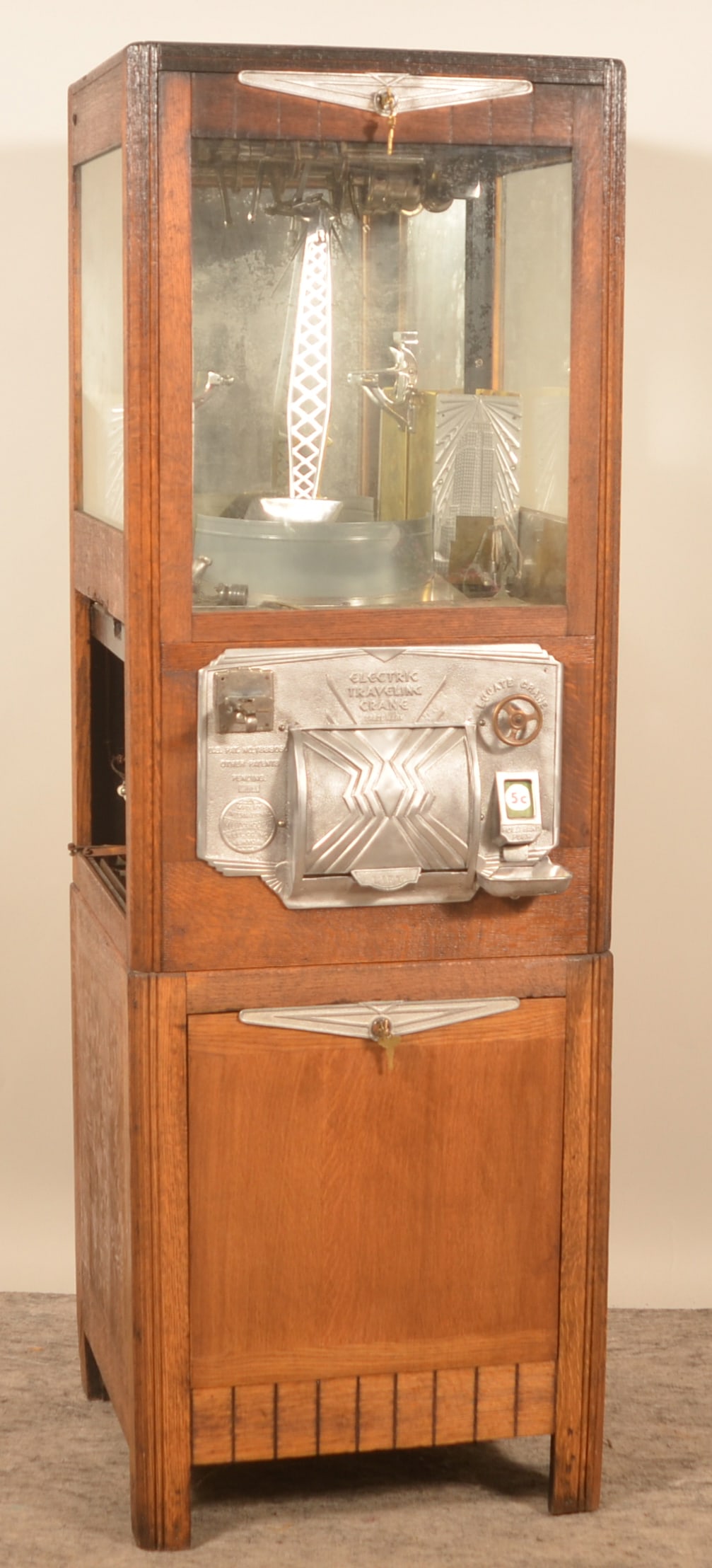 Electric Traveling Crane Penny Arcade Machine: Project machine that has been partially worked on. Provenance: The collection of Russell and Darlene Snyder. 69 1/2"H x 23"W x 21 1/2"D