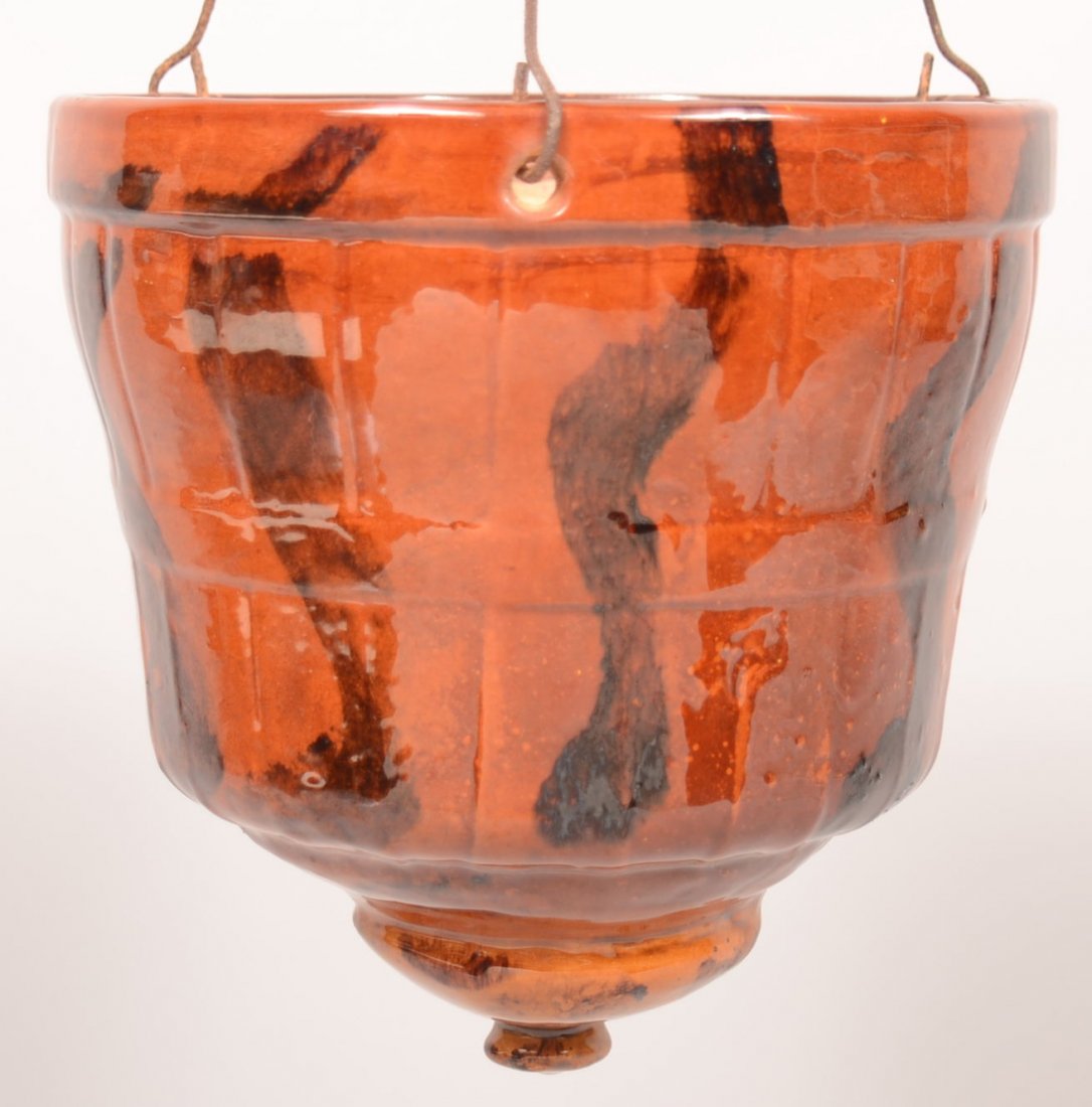 30. Unsigned Redware Pottery Hanging Planter.: 30. Unsigned Redware Pottery Hanging Planter. Attributed to Breininger, Molded design body with brush wavy striped manganese design, 8-1/2"h. x 8- 1/4"dia. Condition: very good.