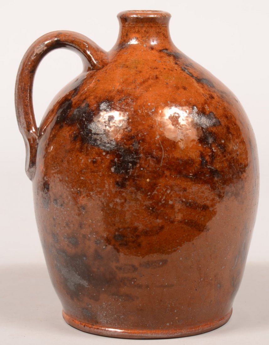 76. 19th Century Redware Jug. Bulbous form with molded: 76. 19th Century Redware Jug. Bulbous form with molded spout and loop handle, Manganese splotch decorations, 8-1/2"h. Condition: Good with minor chip on spout.