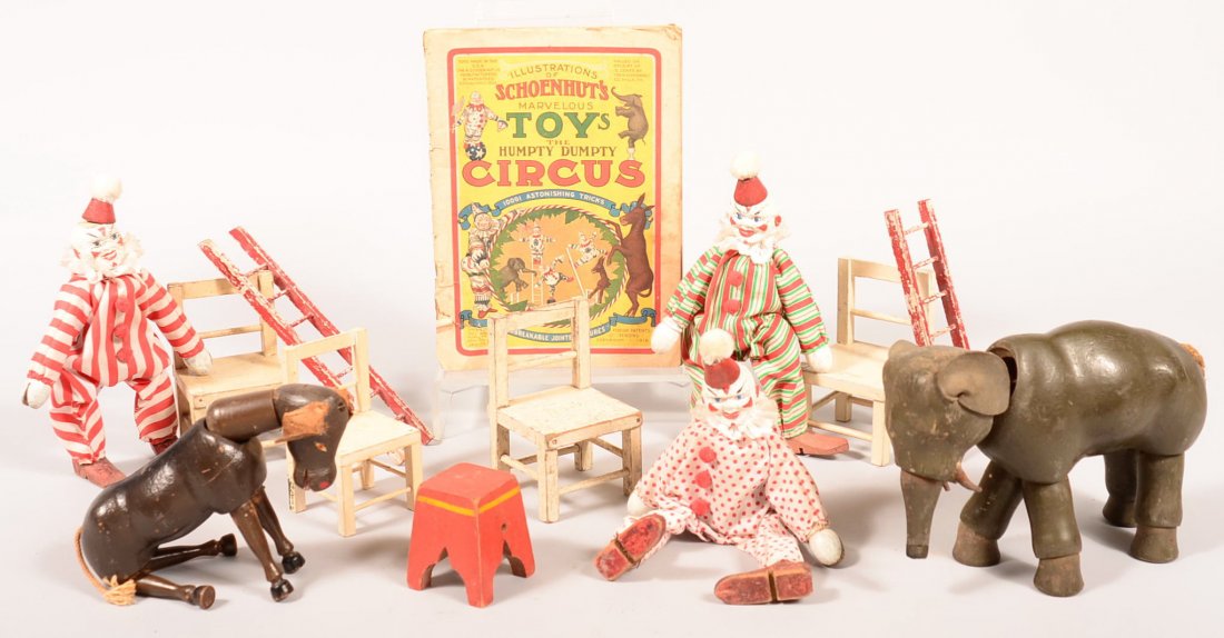 121. Thirteen Pieces of Schoenhut Circus Set. Three: 121. Thirteen Pieces of Schoenhut Circus Set. Three Clowns, Four white chairs, Two red ladders, Elephant, Donkey, Step Stool and Illustrations Schoenhut Toy Catalogue Book, 2-5/8"h.-9"h. Condition: Ov