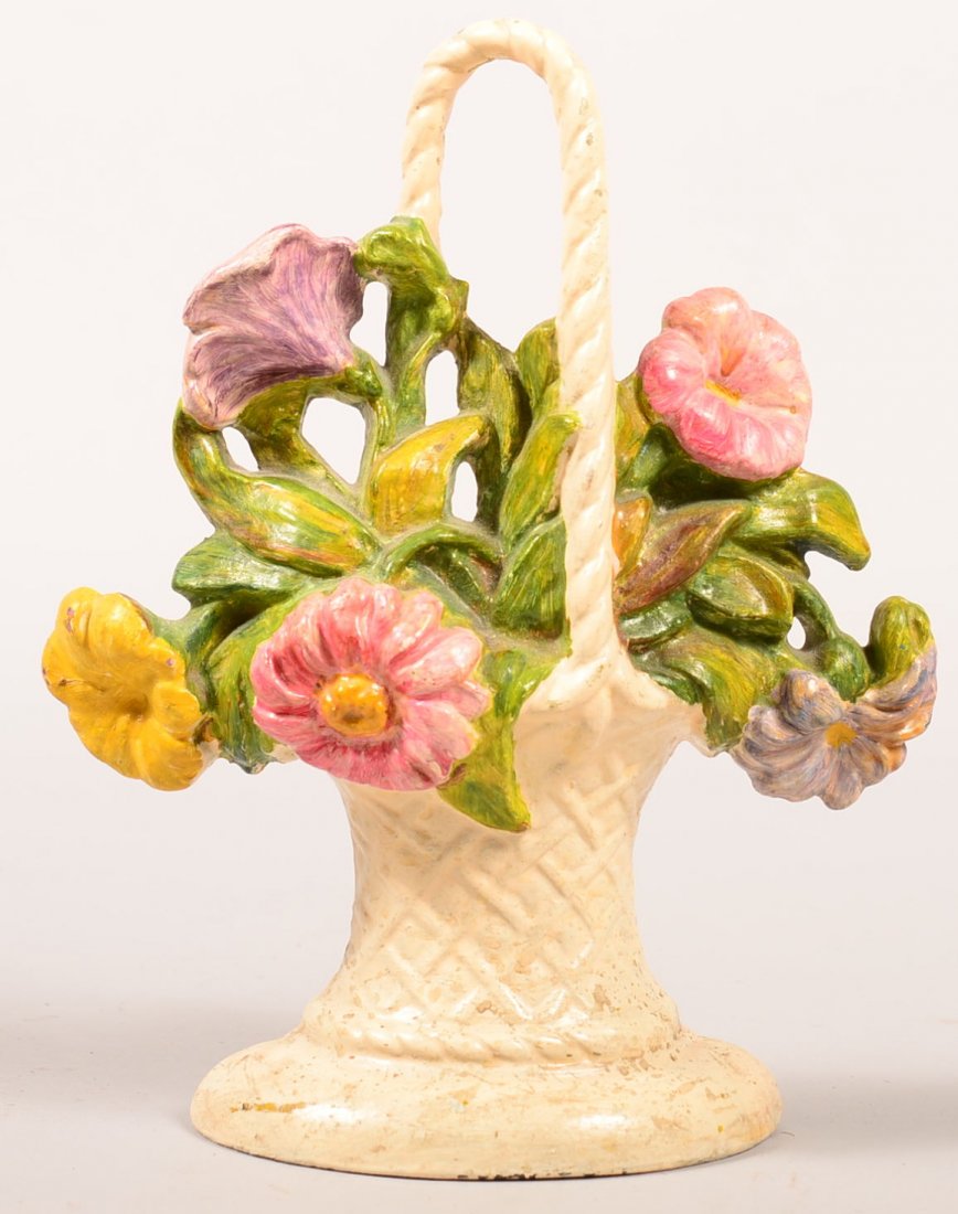 125. Painted Cast Iron Flower Basket Doorstop with: 125. Painted Cast Iron Flower Basket Doorstop with Petunias and Daises, Attributed to Hubley, 9-3/4"h.Condition: Good.