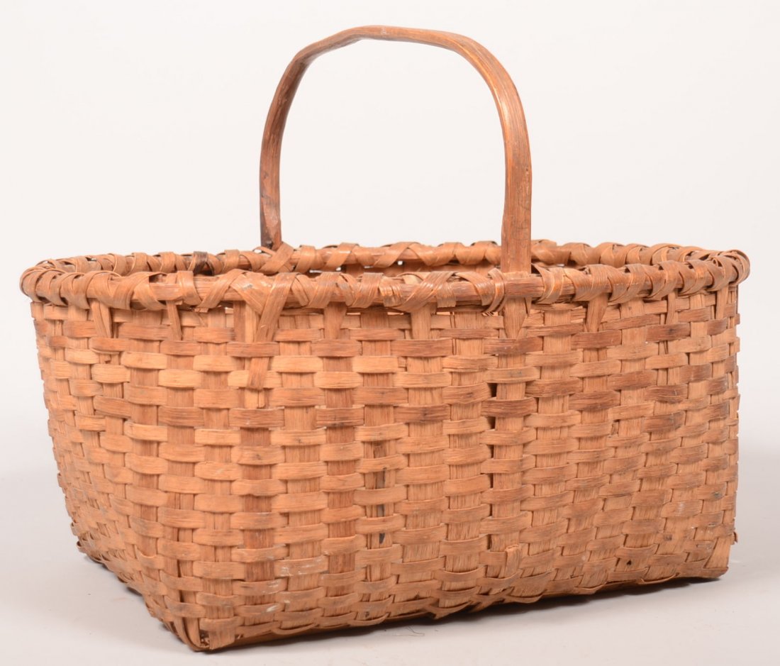 249. Woven Split White Oak Oblong Market Basket. Bent: 249. Woven Split White Oak Oblong Market Basket. Bent wood handle, re-enforce rim and bottom, 16"h.x22"l.x17"d.Condition: Good with minor breaks.