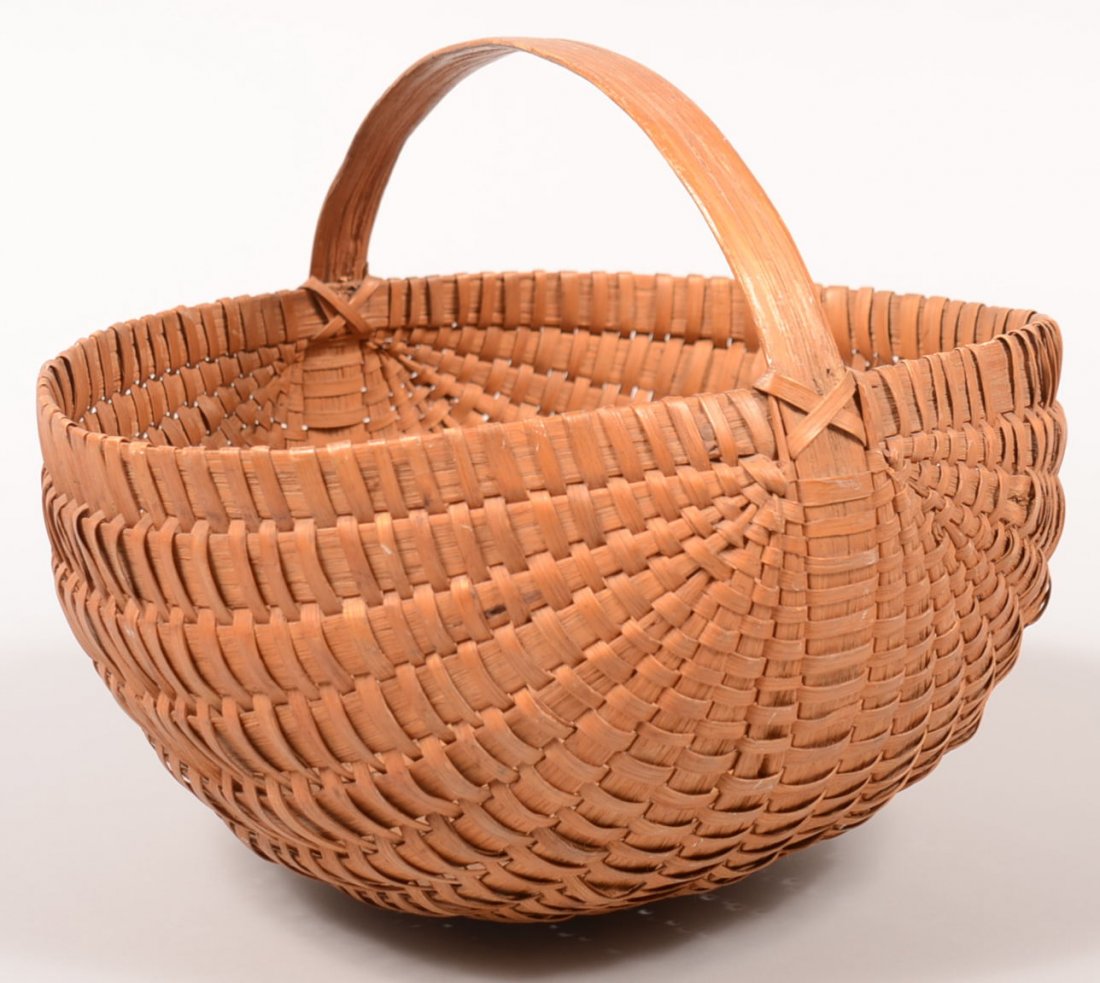 252. Woven Split White Oak Basket. Round form with: 252. Woven Split White Oak Basket. Round form with ribbed construction and bentwood handle,10"h.x12"x13-1/2". Condition: Good with minor break.