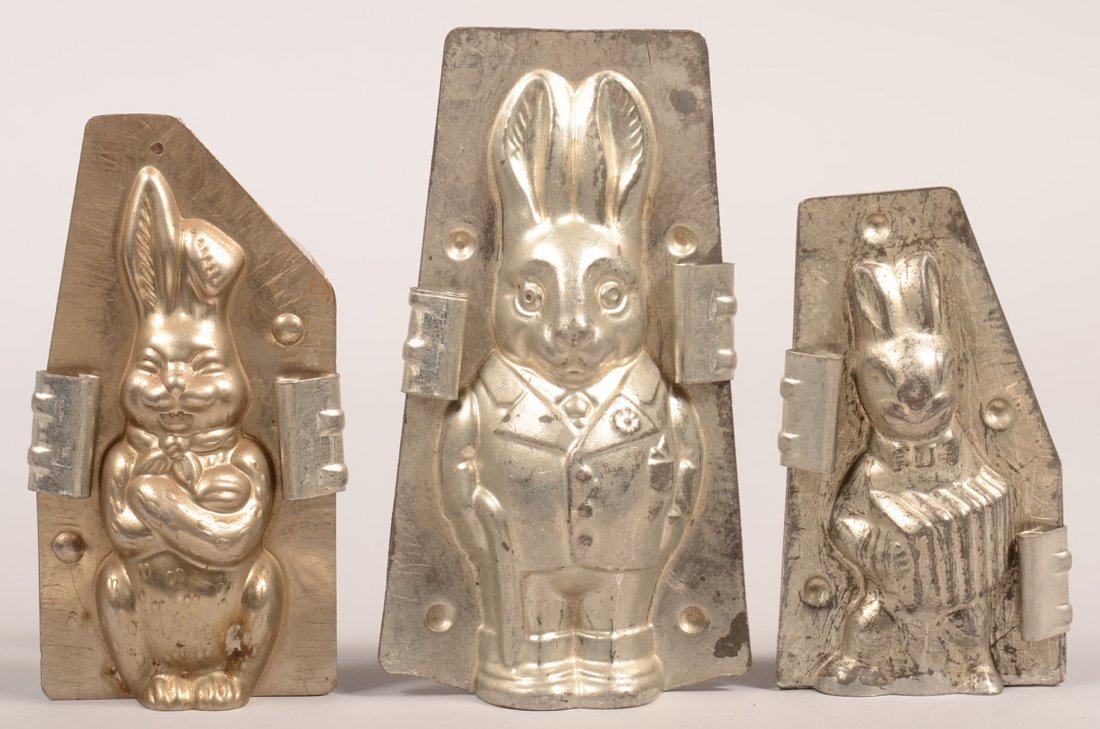 314. Three Small Standing Rabbit Chocolate Molds.: 314. Three Small Standing Rabbit Chocolate Molds. Dressed character rabbit signed Rheinania Reinerfischer Koln, Arm Crossed and Rbbit playing accordion, 5"-6-1/4"h. Condition: Good.