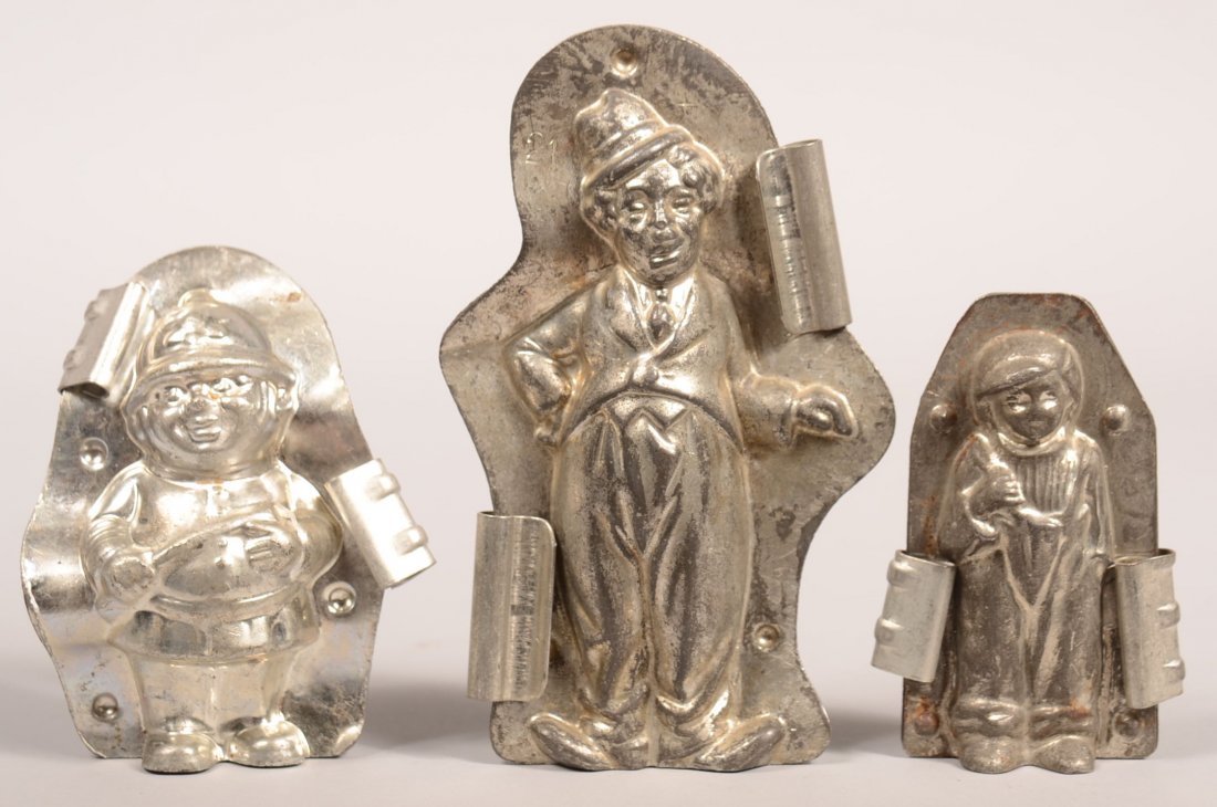 318. Three Character Chocolate Molds. Charlie Chaplin: 318. Three Character Chocolate Molds. Charlie Chaplin #20438 s, Policeman, Man wearing bid overalls and hat(#3697), 4"h.- 6-1/4"h. Condition: Good.